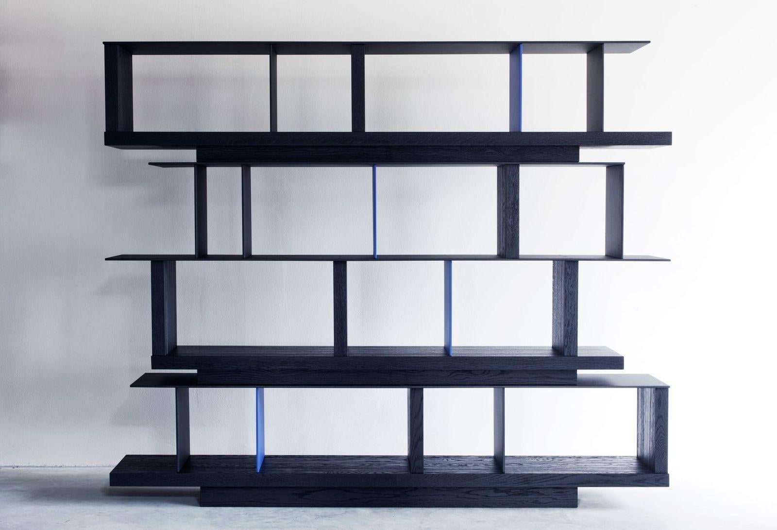 Kitale bookcase by Van Rossum
Dimensions: D250 x W40 x H205 cm
Materials: Oak, steel.

The wood is available in all standard Van Rossum colors, or in a matching finish to customer’s own sample.
The steel bases are available in four colors or in