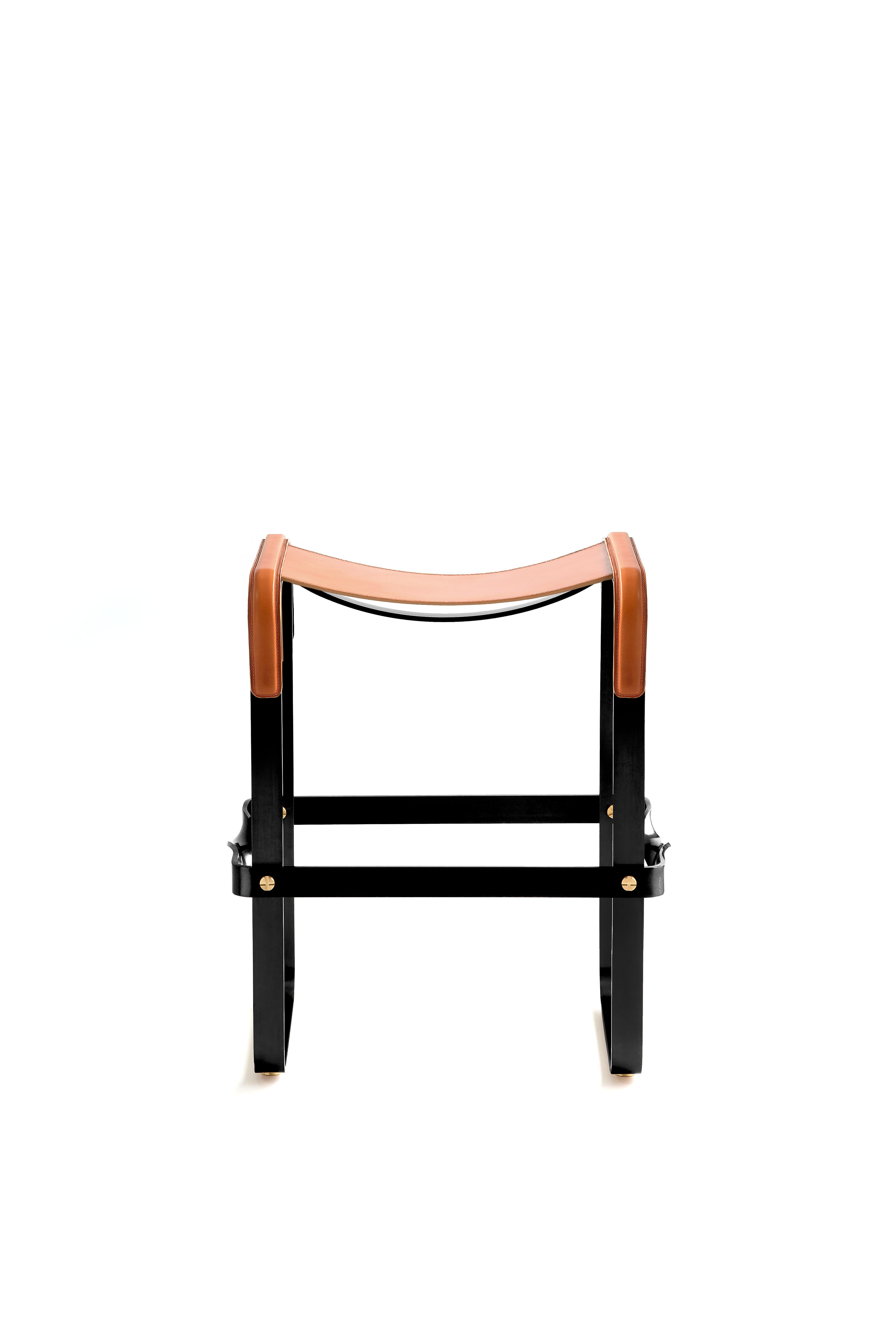 Counter stool in black smoke polished steel and Natural Tobacco saddle leather.

The phrases 