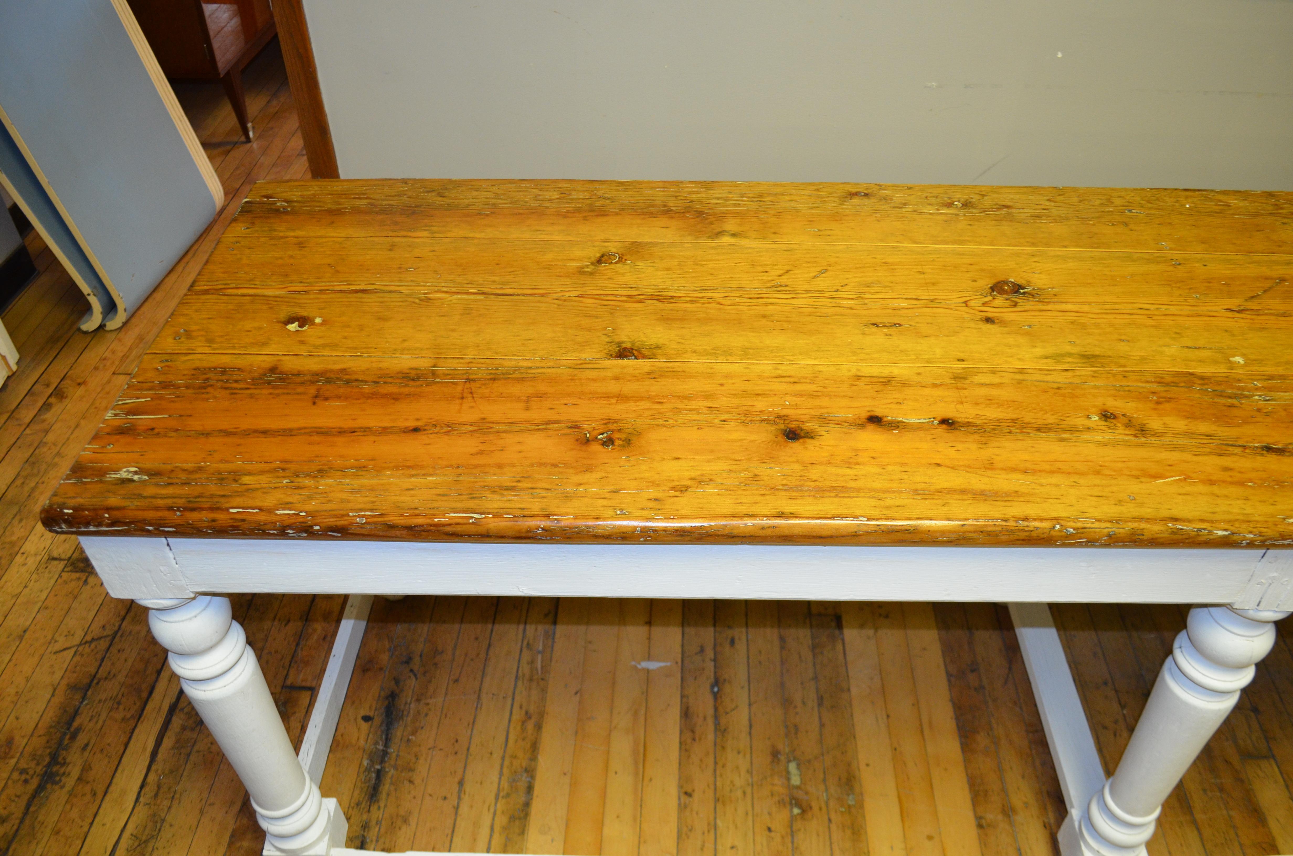 Kitchen island or restaurant prep table or centre hall, office console hails from New Orleans rectory, early 20th century. Pine board top has been refinished food safe. Supporting balustrade legs with stringers have been painted with white milk