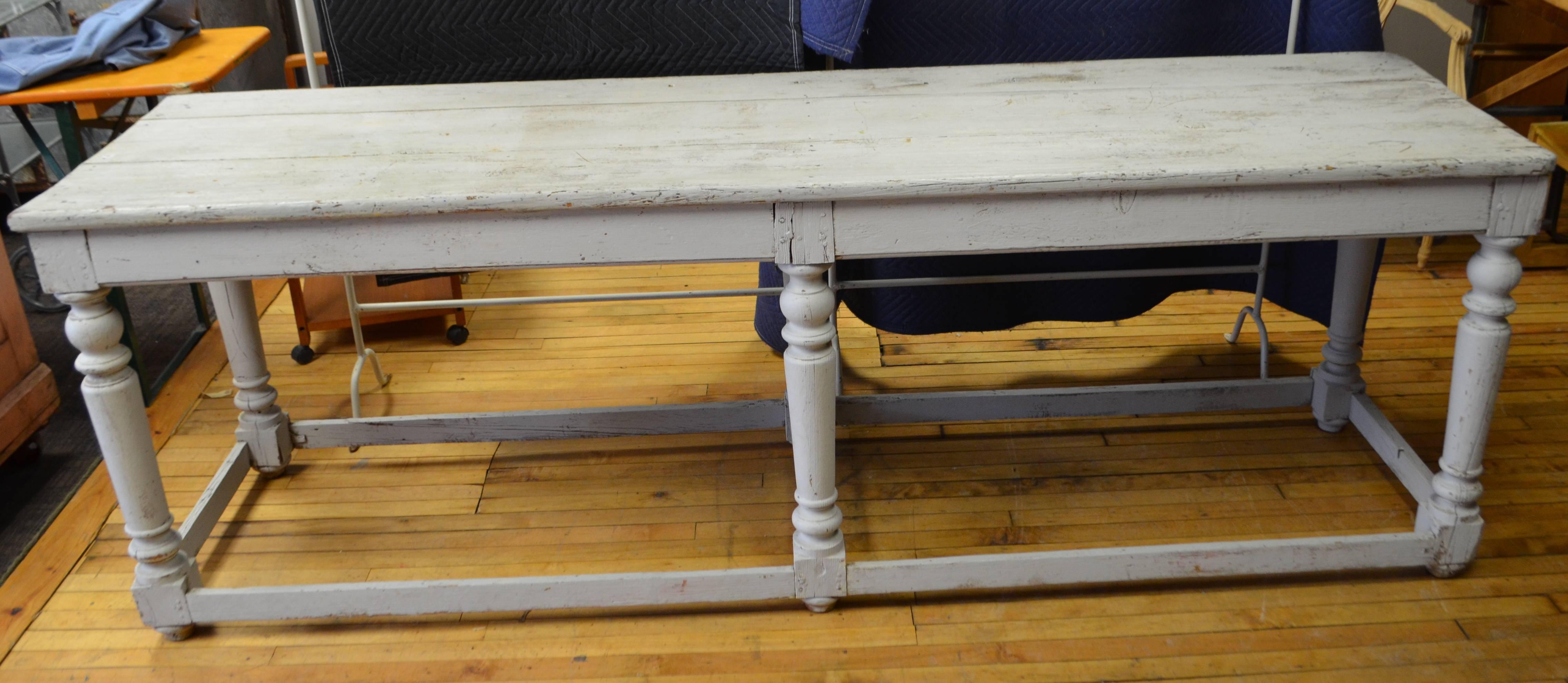 Kitchen island or restaurant prep table or center hall console hails from New Orleans, early 20th century. Wooden plank top with hand- turned support columns. Can be easily-shortened or raised with wheels to height of your choice.