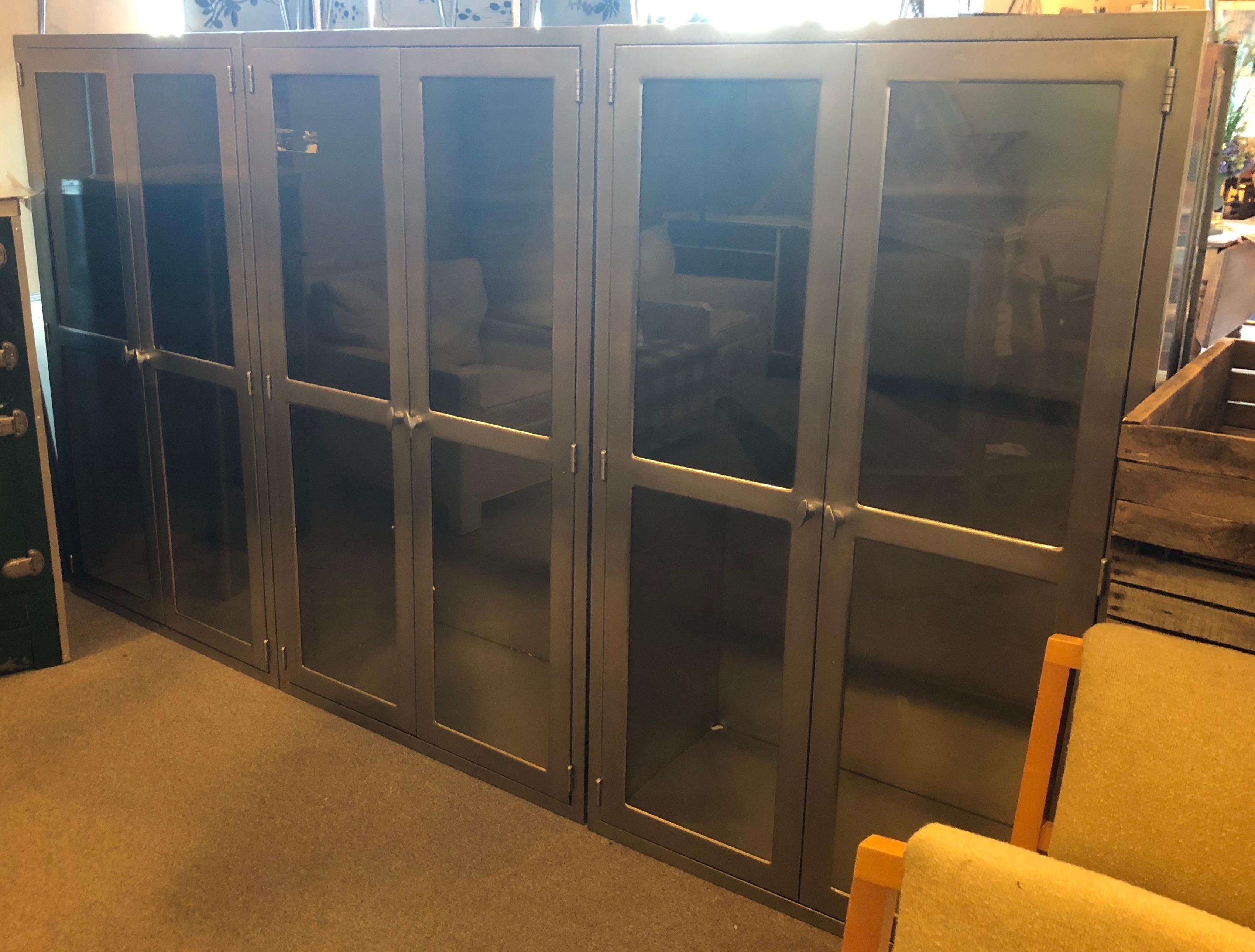 Medical cabinets of stainless steel and glass. Set of 3. Two adjustable stainless steel shelves per cabinet or six shelves in total. These were removed from a hospital as built-ins. In excellent condition. Ideal for building into new construction.