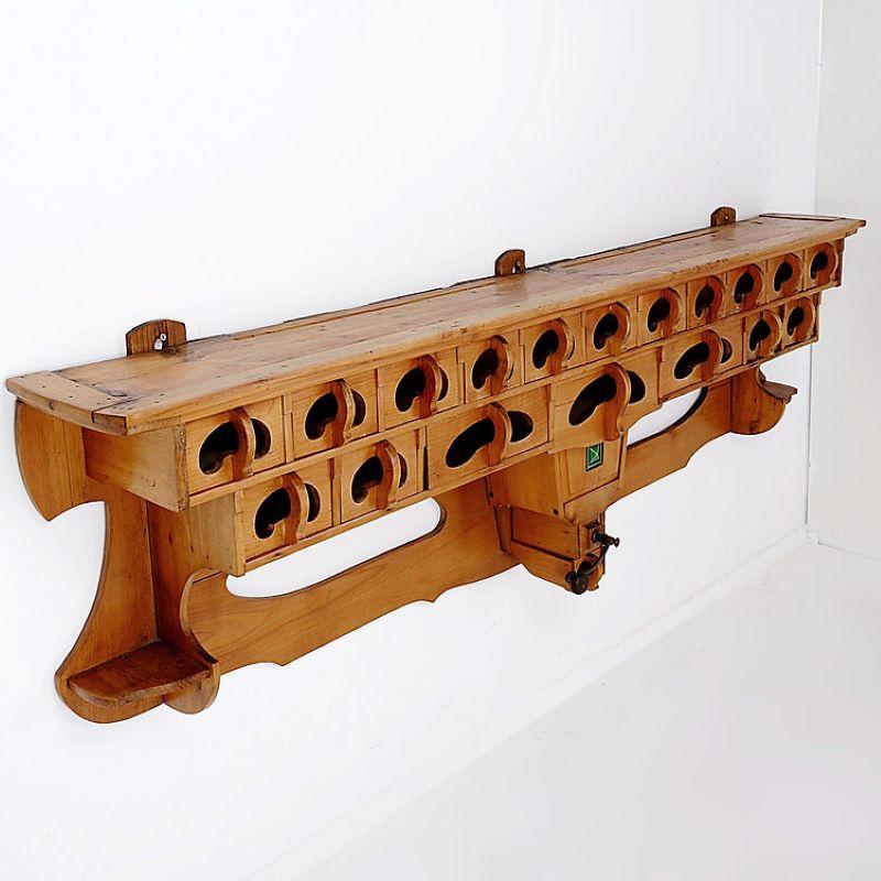 Formidable kitchen rack, with no less than 18 drawers, and a small manual coffee grinder. The rack also has four hooks on either side of the beautifully carved centerpiece, which can hold on to pots, pans, towels or aprons. The centerpiece is