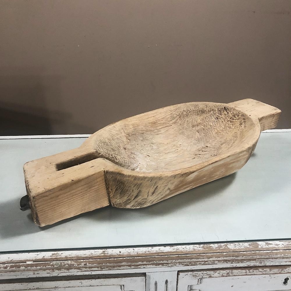 19th century kitchen spoon cradle carved from a single block of wood, was cleverly designed to keep an oft-used utensil at hand, with an ingenious drain hole and spout drilled and carved into the design,
circa 1850s
Measures: 4.5 H x 25.5 W x 11.5 D.