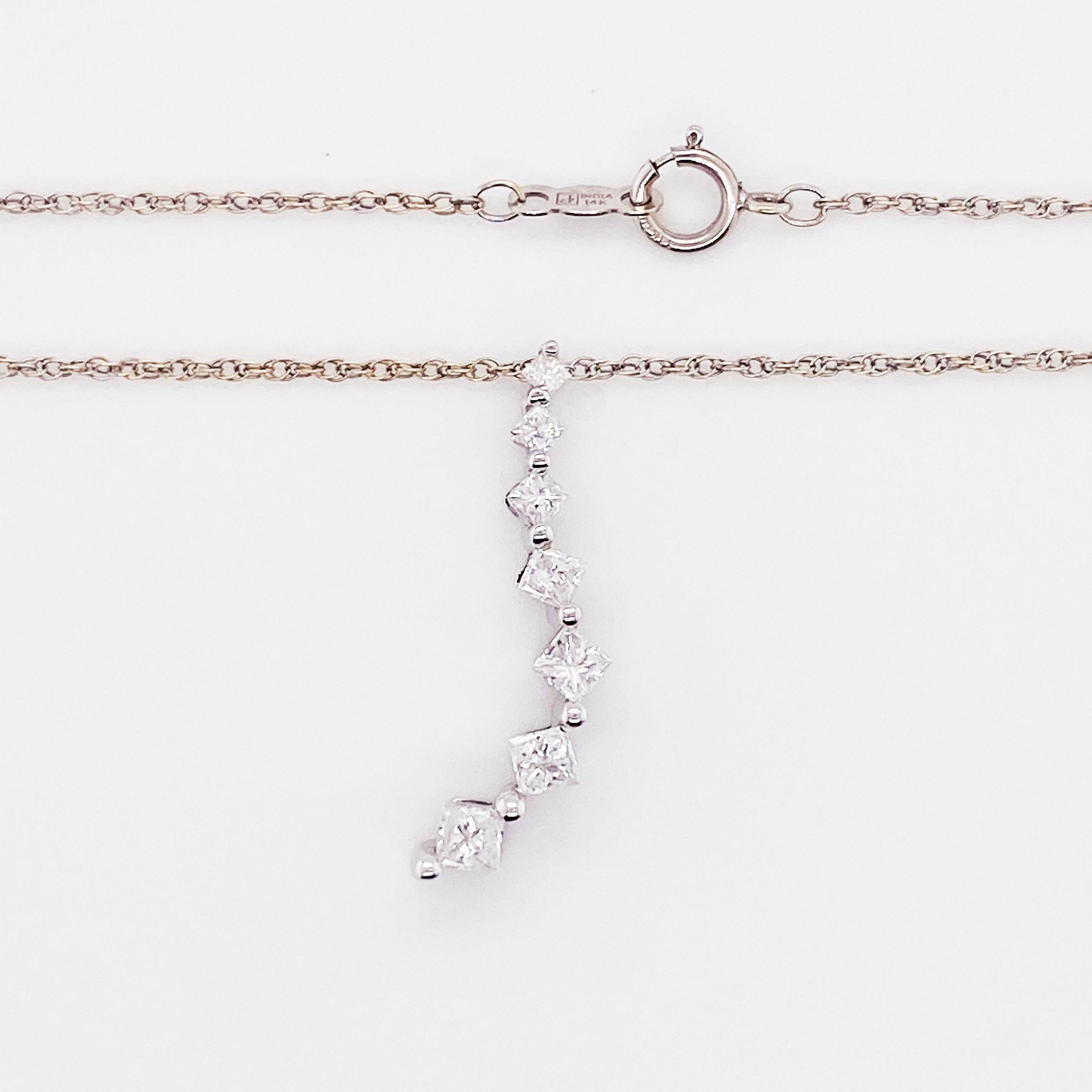 This diamond necklace looks like a kite flying in the air!  It has seven (7) princess cut diamonds that are all different sizes.  It starts with a smaller princess cut diamonds at the top and tapers to larger diamonds as you get down to the longest