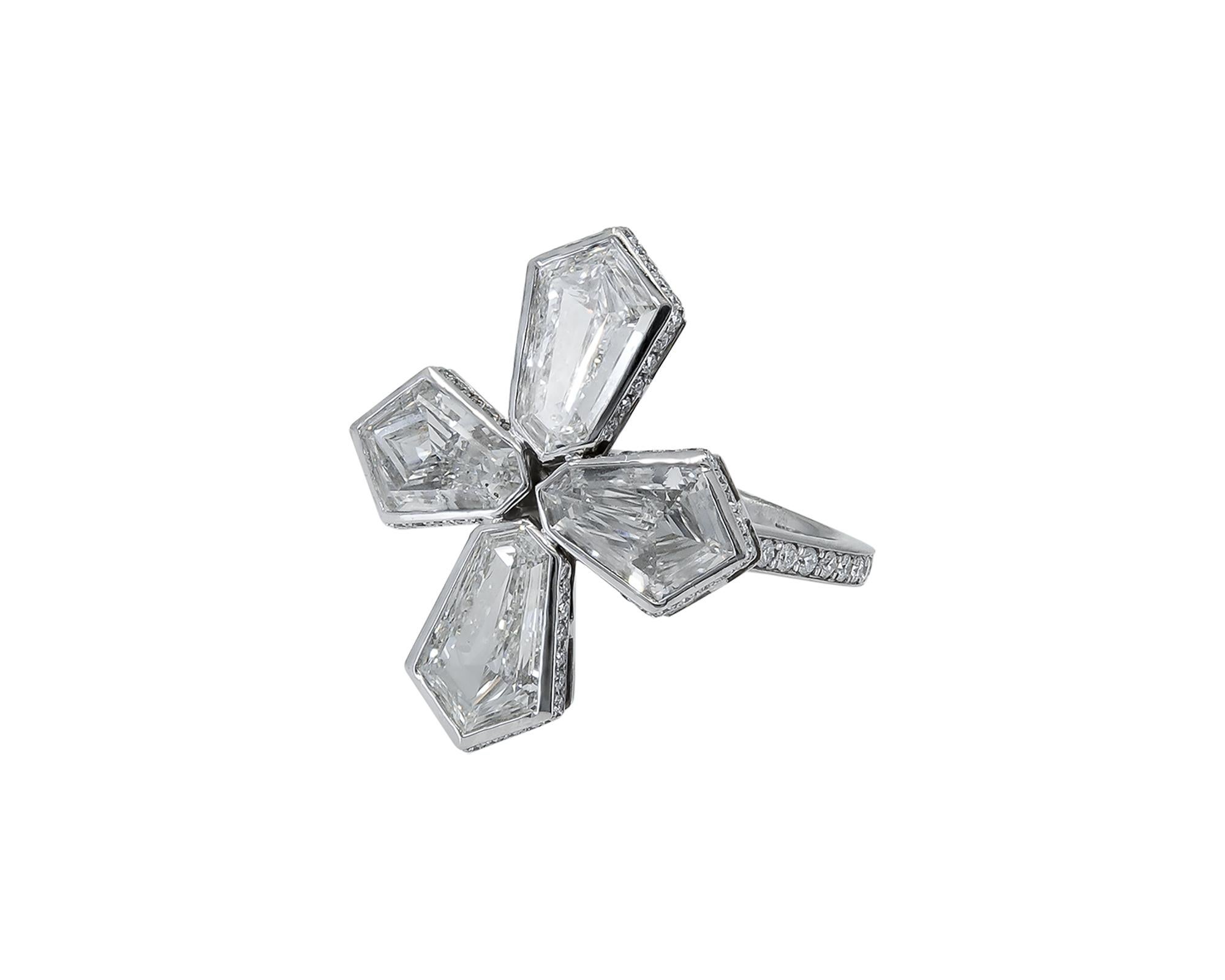 A fancy stylish ring designed as a cross and embellished with four kite-shaped diamonds. Set in platinum.
The diamonds are not certified and are estimated as J color and VVS2 clarity. Total carat weight is 6.47.
Pave diamonds on the band