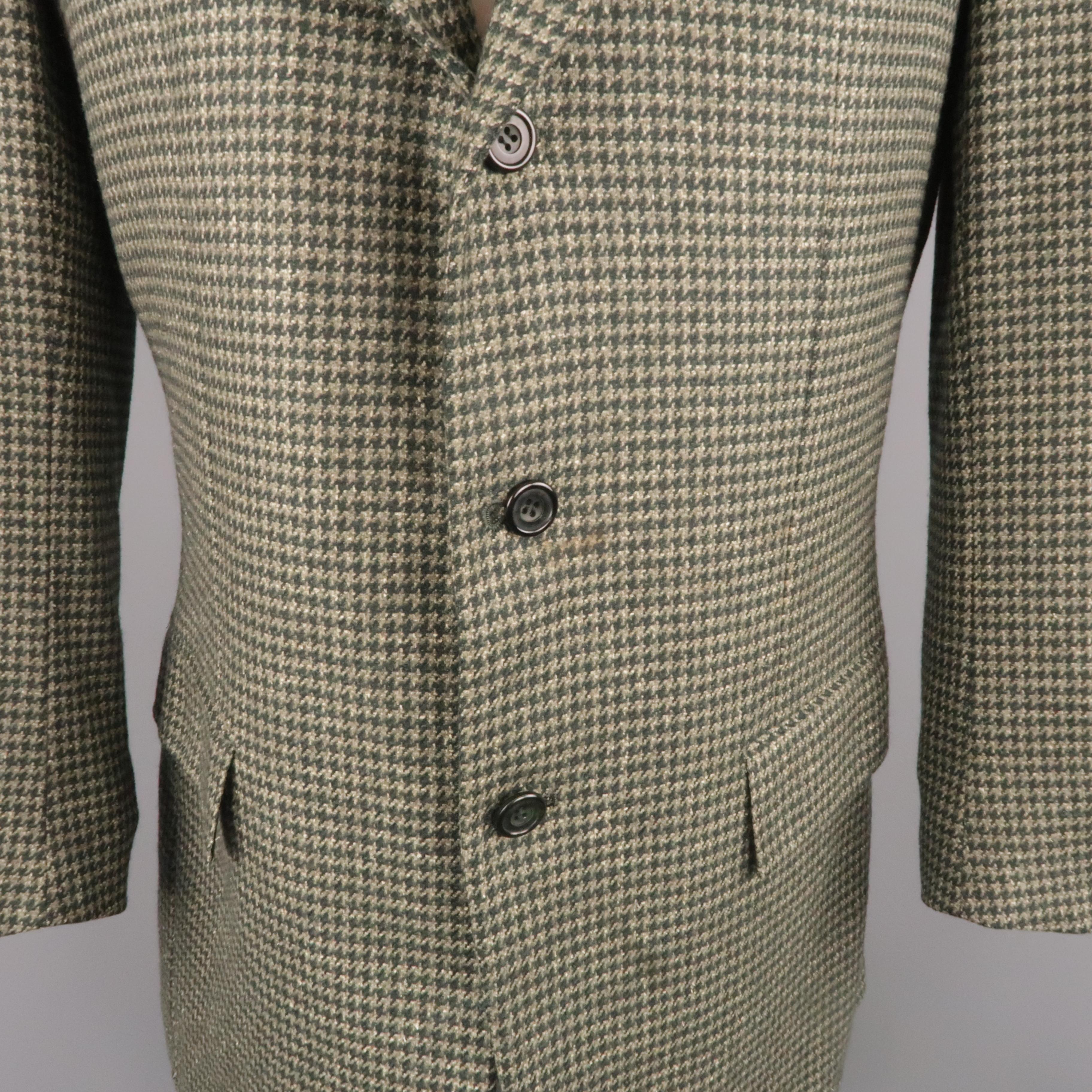 Vintage KITON sport coat comes in green houndstooth cashmere with a notch lapel, single breasted,  three button front, silk lining, and functional button cuffs. Spot on front. As-is. Made in Italy.
 
Good Pre-Owned Condition.
Marked: IT 50
