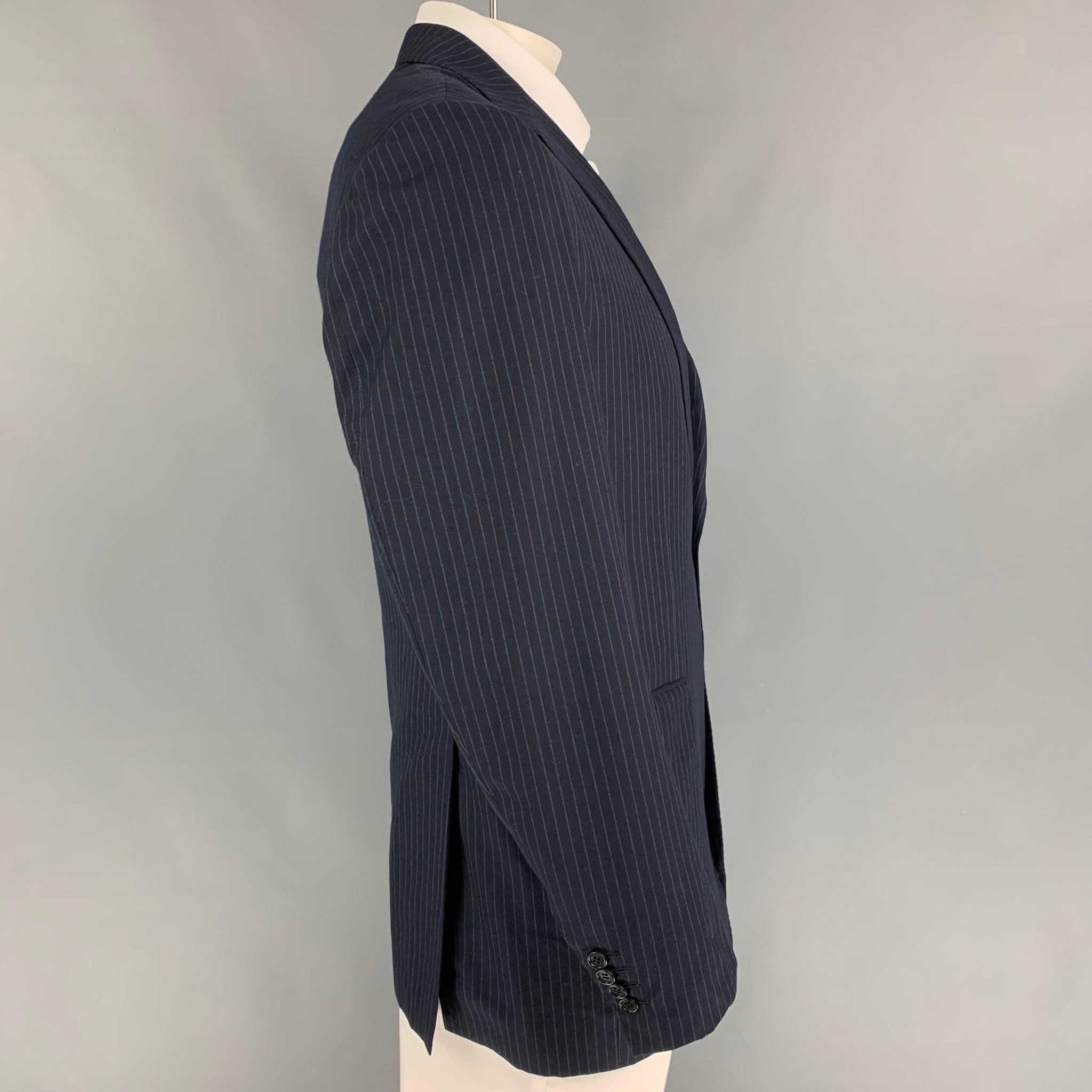 KITON for NEIMAN MARCUS sport coat comes in a navy & white pinstripe wool with a full liner featuring a notch lapel, flap pockets, double back vent, and a double button closure. Made in Italy. 

Very Good Pre-Owned Condition.
Marked: