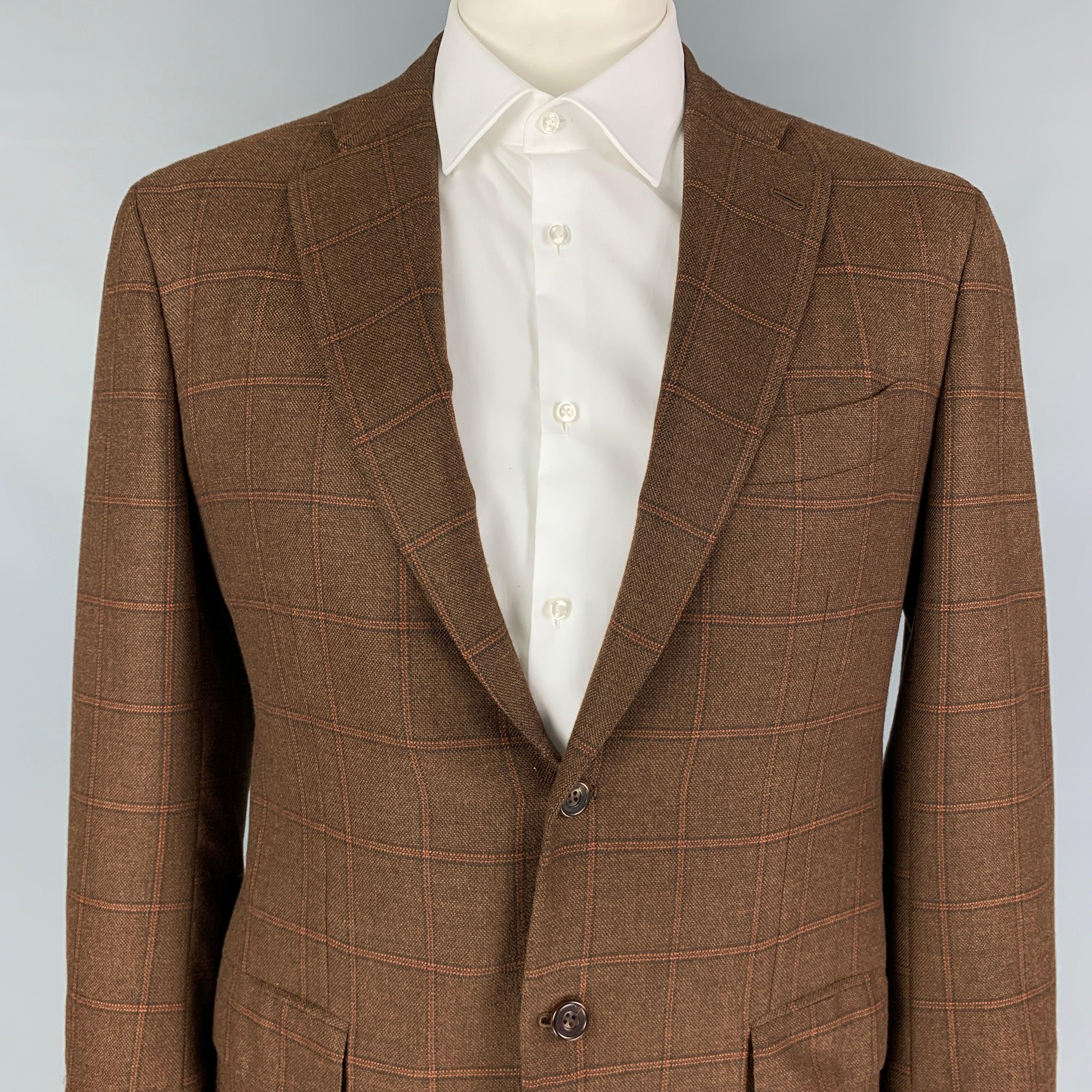 KITON sport coat comes in a brown & orange window pane cashmere with a full liner featuring a notch lapel, flap pockets, double back vent, and a double button closure. Made in Italy.
 Excellent
 Pre-Owned Condition. 
 

 Marked:  54 
 

