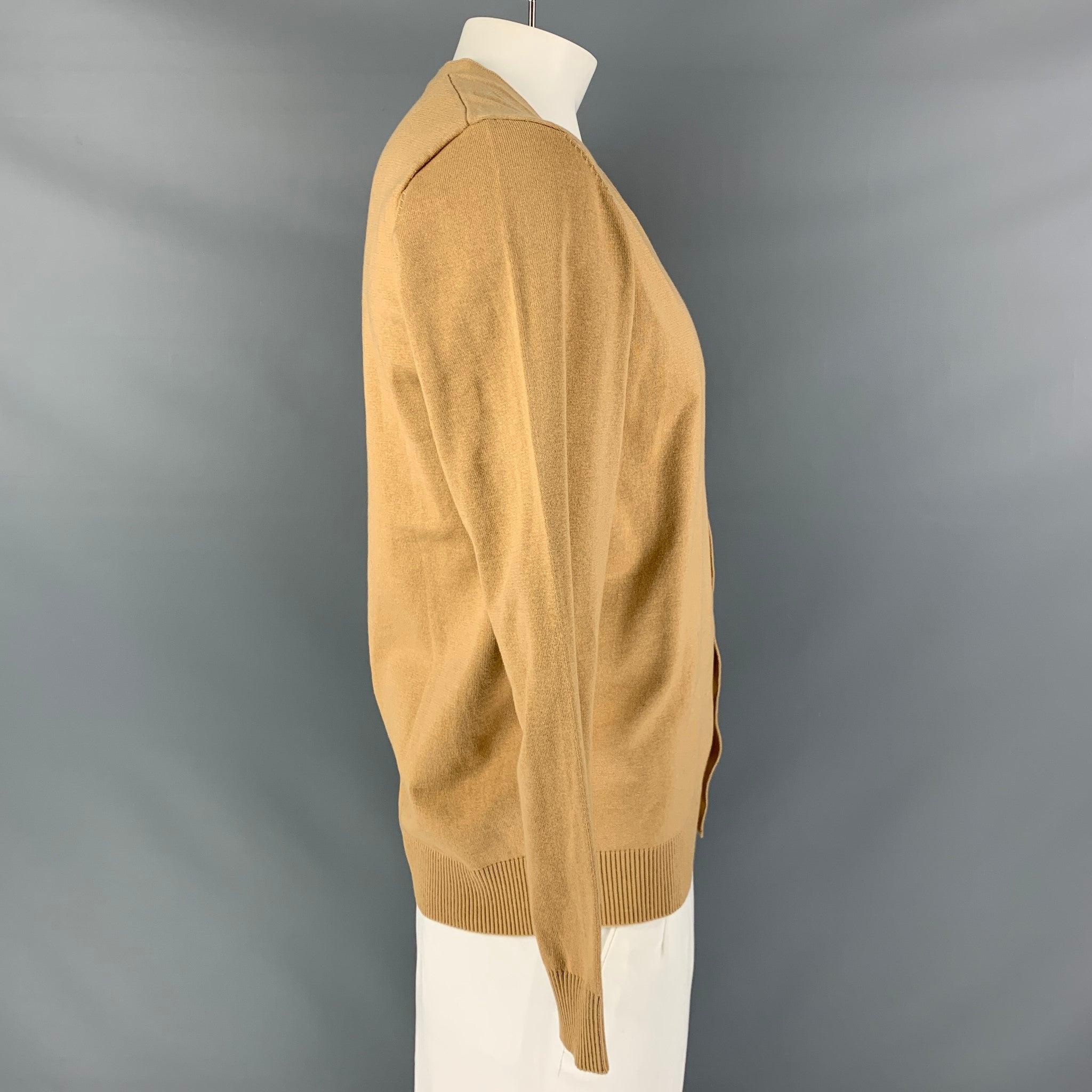 KITON cardigan comes in a beige cashmere and silk knit featuring a V-neck and button up closure. New With Tags. 

Marked:   L 

Measurements: 
 
Shoulder: 18 inches Chest: 46 inches Sleeve: 25 inches Length: 27 inches 

  
  
 
Reference: