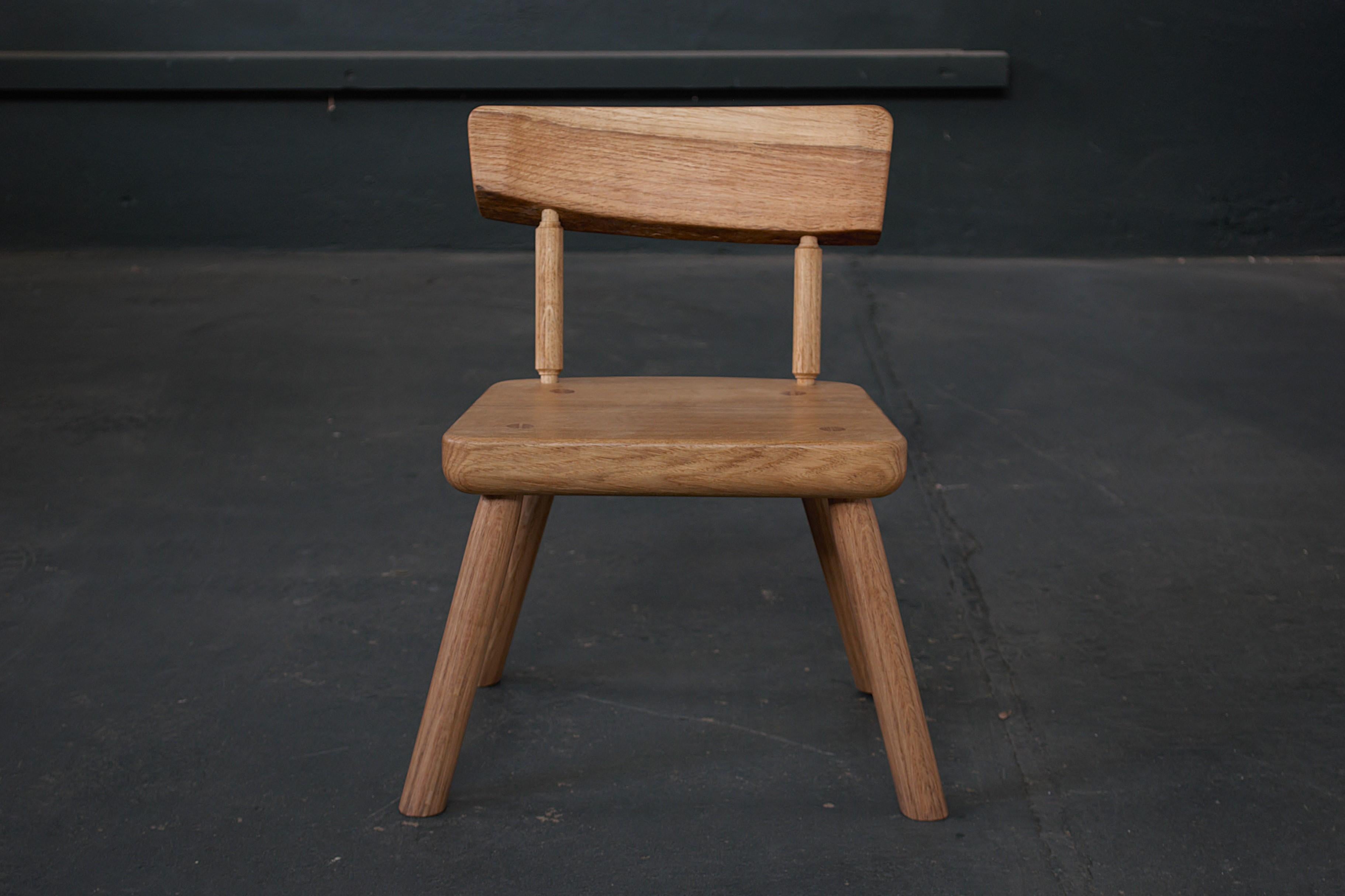 Based on a chair made for James’ toddler son, this cute little oak chair suits a child aged 2-5 years old. The legs and spindles are rounded by hand with planes and spokeshaves so they have many facets that catch the light unevenly. The back rest is