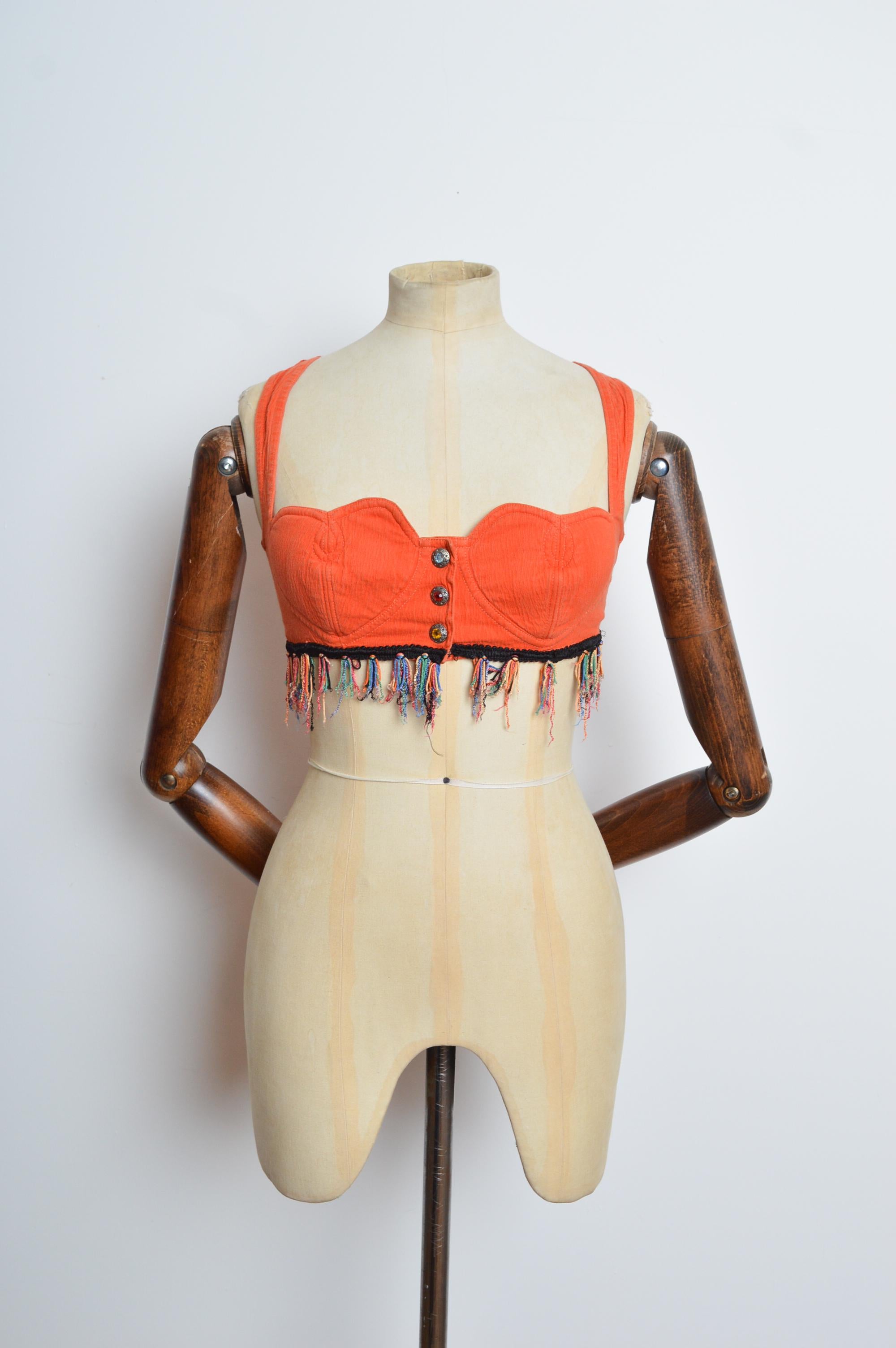Fabulous 1990's MOSCHINO Orange coloured stretchy denim crop top with heart shaped breasts and bejewelled buttons down the front. 
MADE IN ITALY. 
Size Fits a modern UK 6 beautifully.
Under the bust measures 28