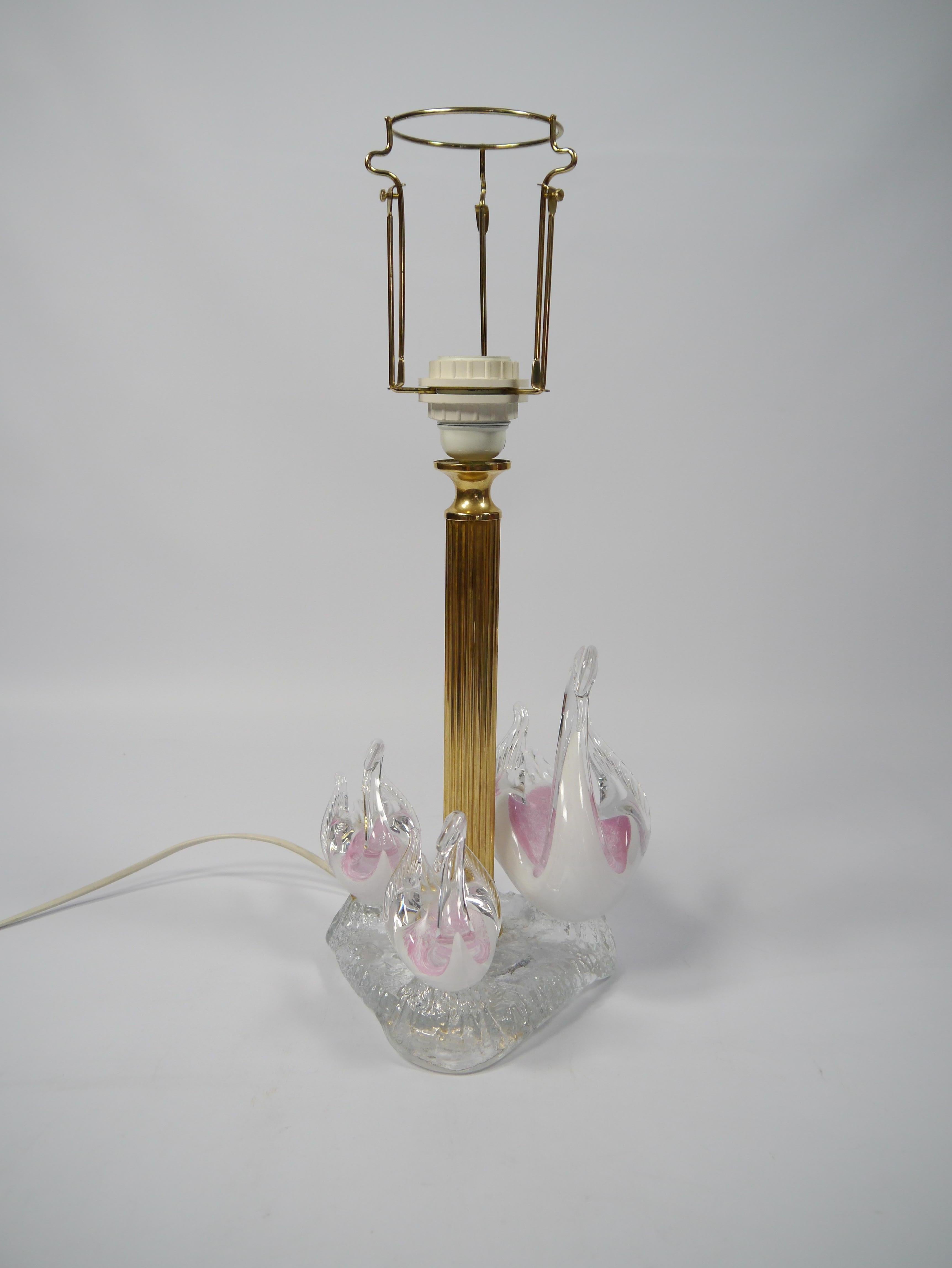 Kitsch brass and glass table lamp, featuring three art glass swans in pinkish hues.