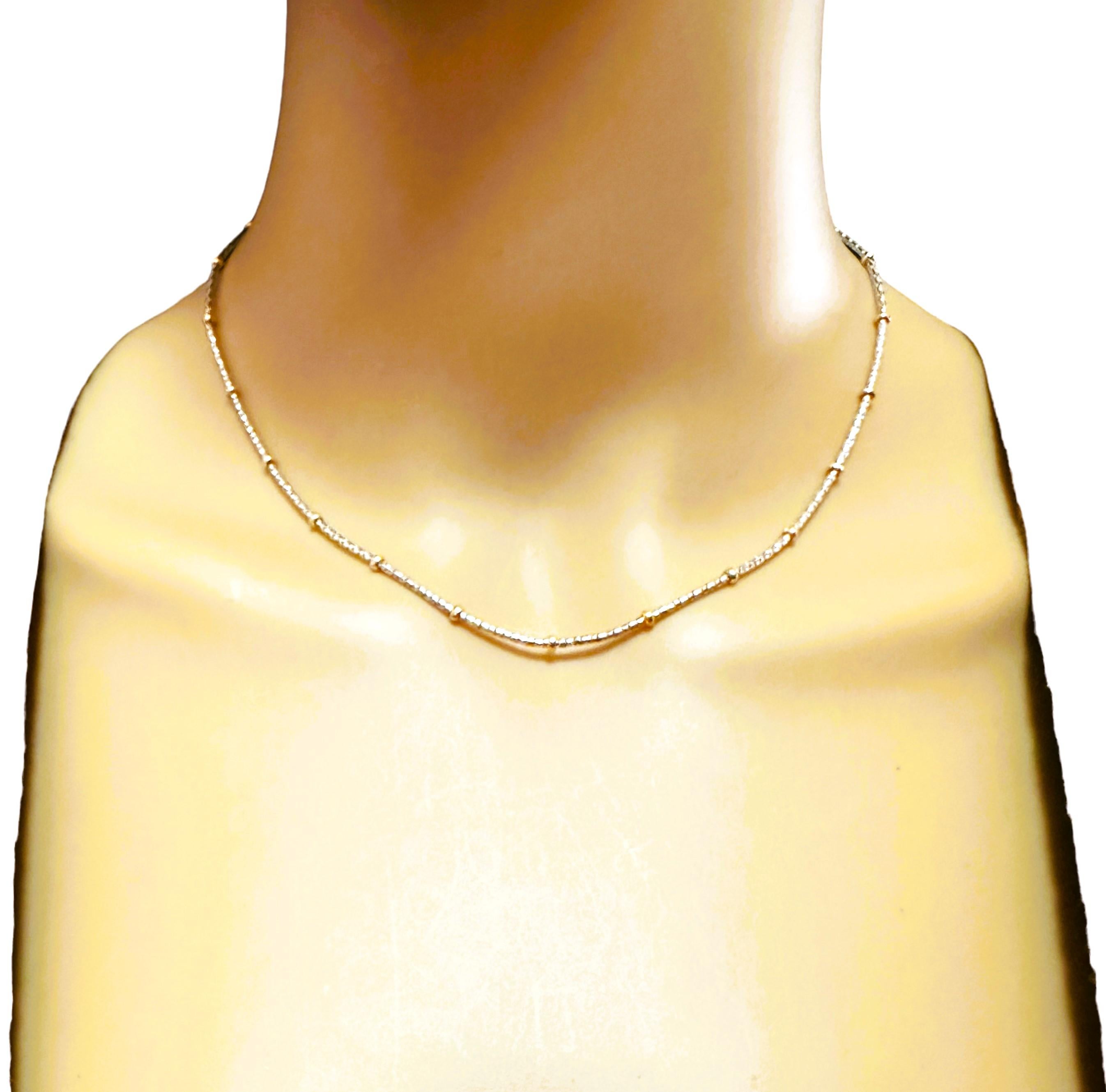 This necklace is just very well made.  It is such a quality made piece made by the Kitsinian Jewelers.  It is a 14K White Gold laser chain with stationed 14k Yellow Gold beads.  The two colors make it very versatile.  It is stamped 