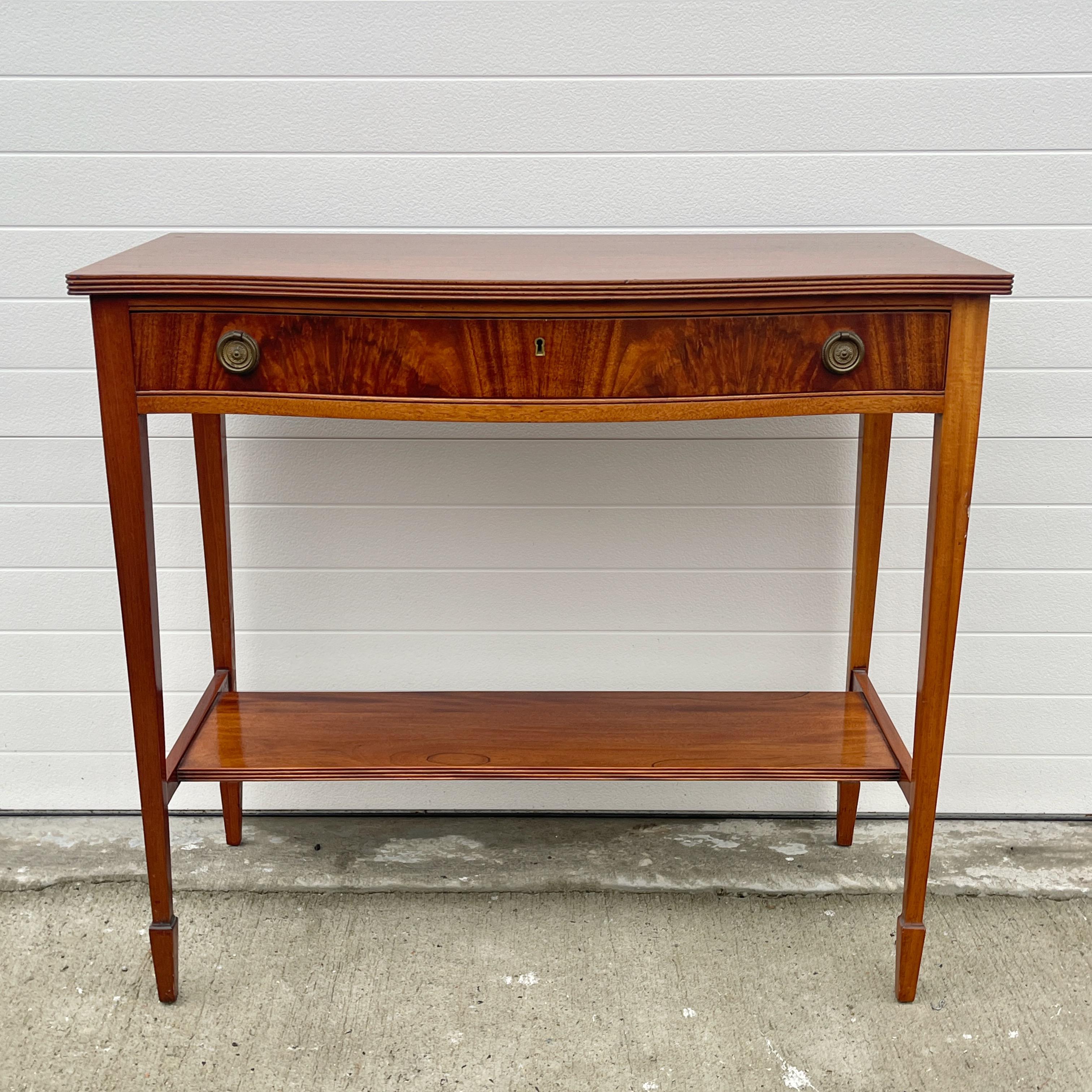 Federal style mahogany console with a demilune top above a drawer and lower shelf.