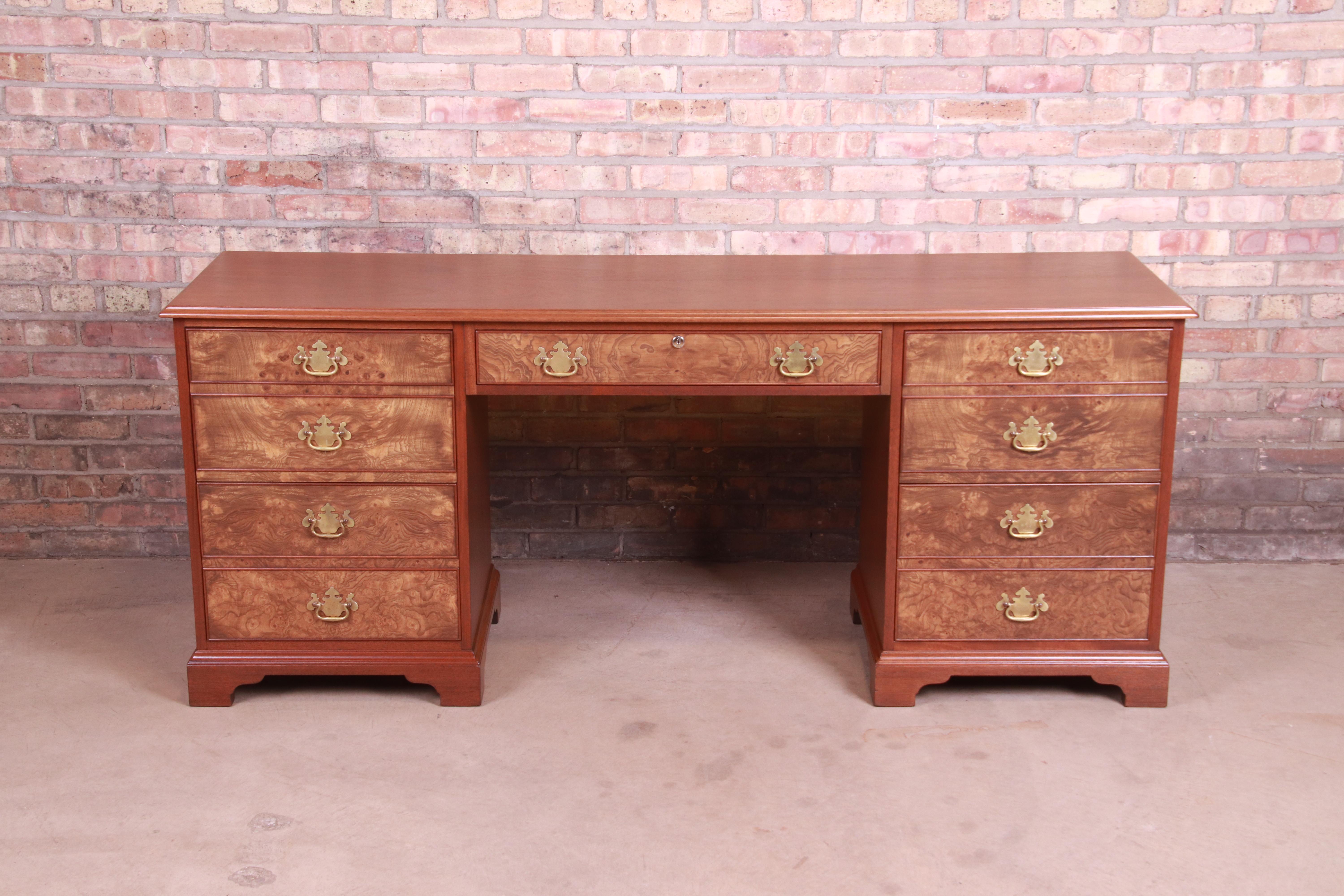An exceptional English Chippendale style kneehole desk or credenza

By Kittinger

USA, circa 1960s

Mahogany, with burled walnut drawer fronts, and original brass hardware.

Measures: 71.5