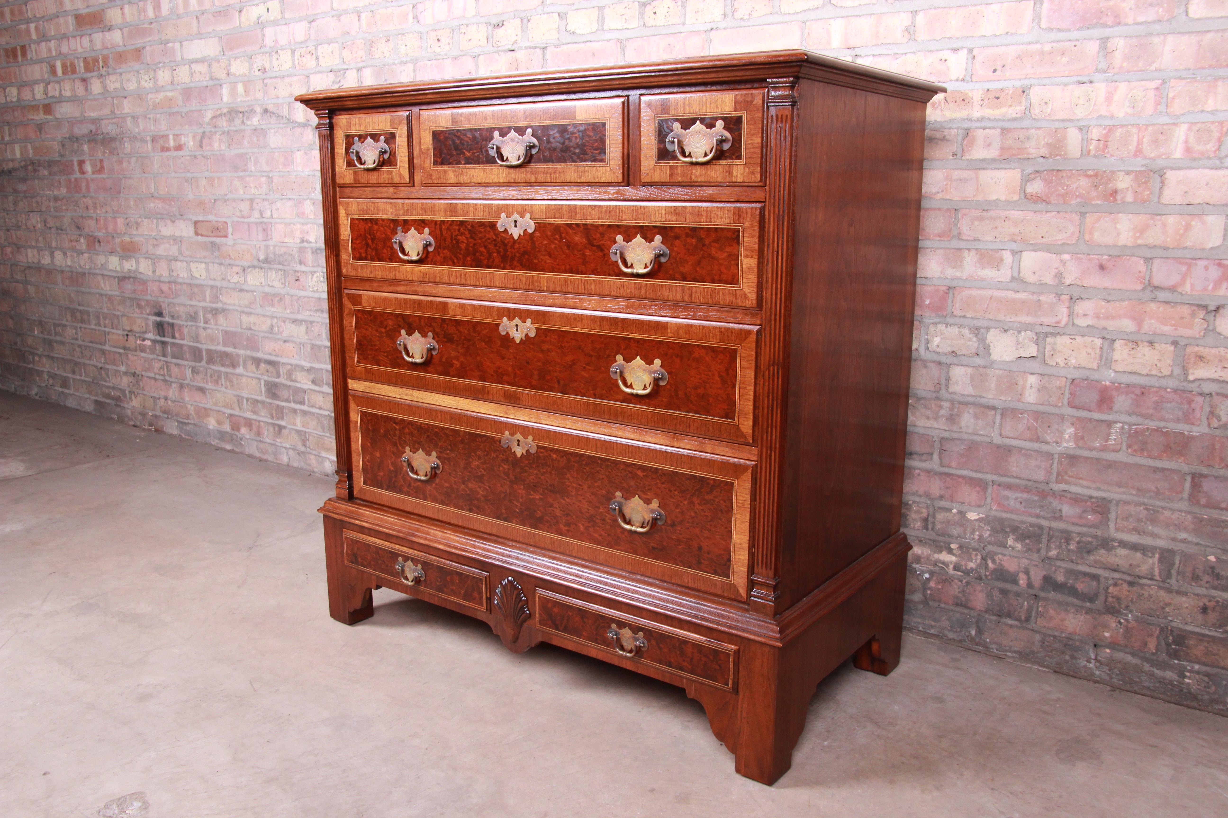 An exceptional Chippendale style dresser or chest of drawers

By Kittinger Furniture

USA, circa 1930s

Solid walnut, with burled walnut drawer fronts and original brass hardware.

Measures: 40