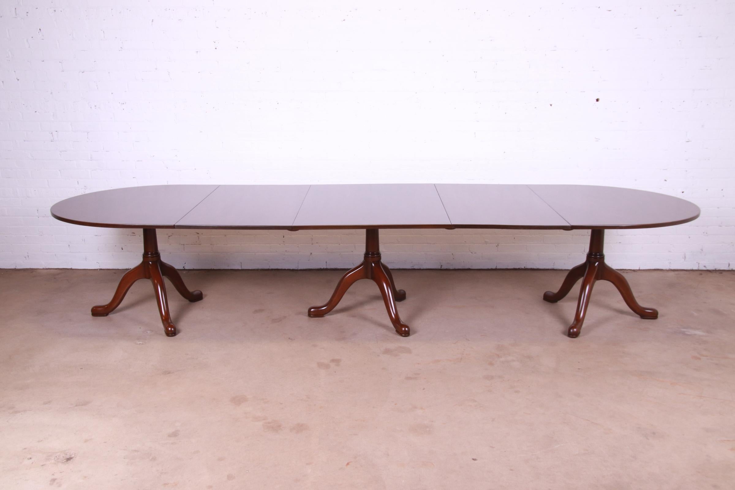 A gorgeous Georgian style solid mahogany triple pedestal extension dining table

By Kittinger, 