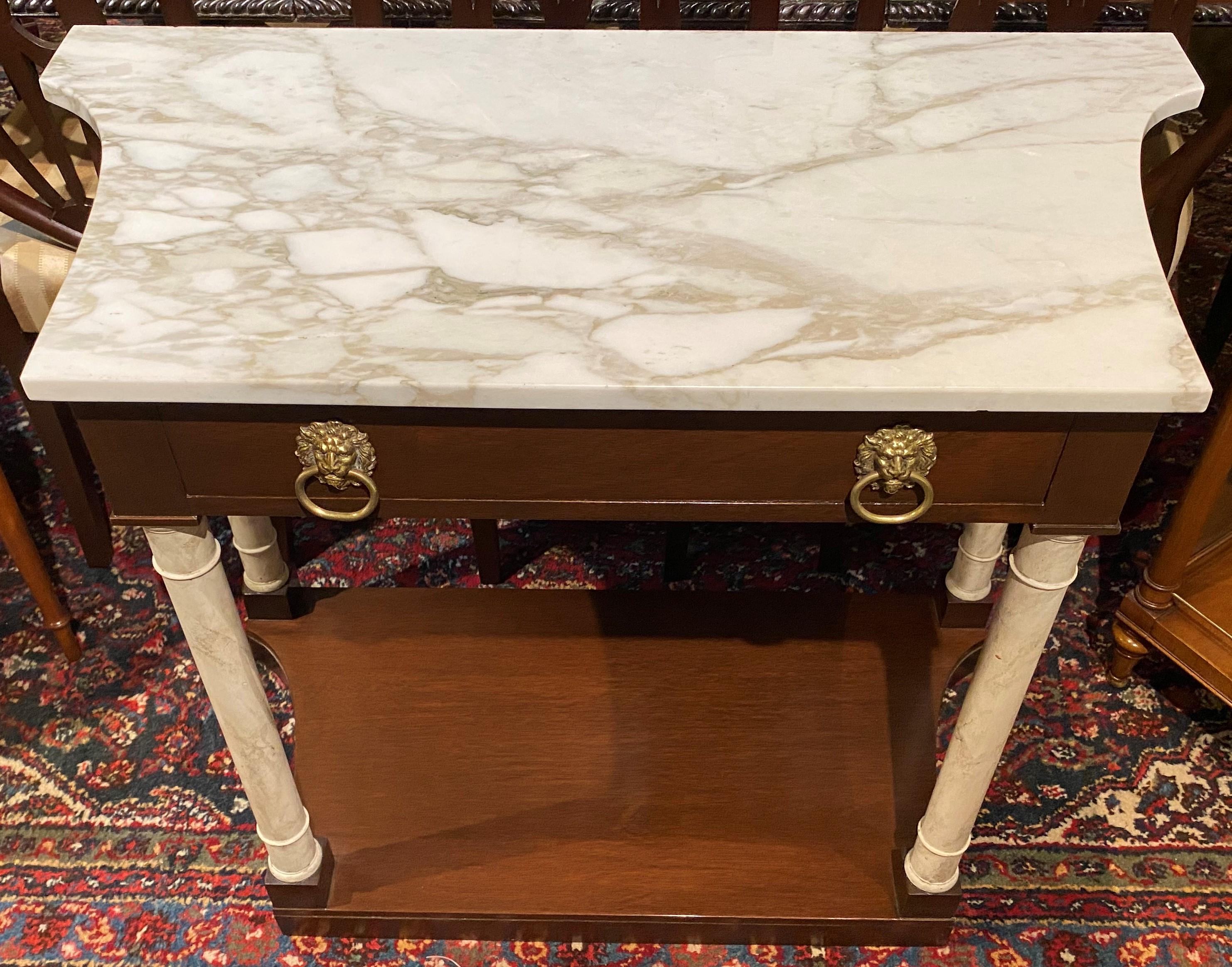 A classical form custom marble top shaped single drawer console with faux marble painted wooden pilasters, shaped base, and solid brass lions head round pulls. A Kittinger metal tag appears inside the drawer, along with a Gainsborough Finish label
