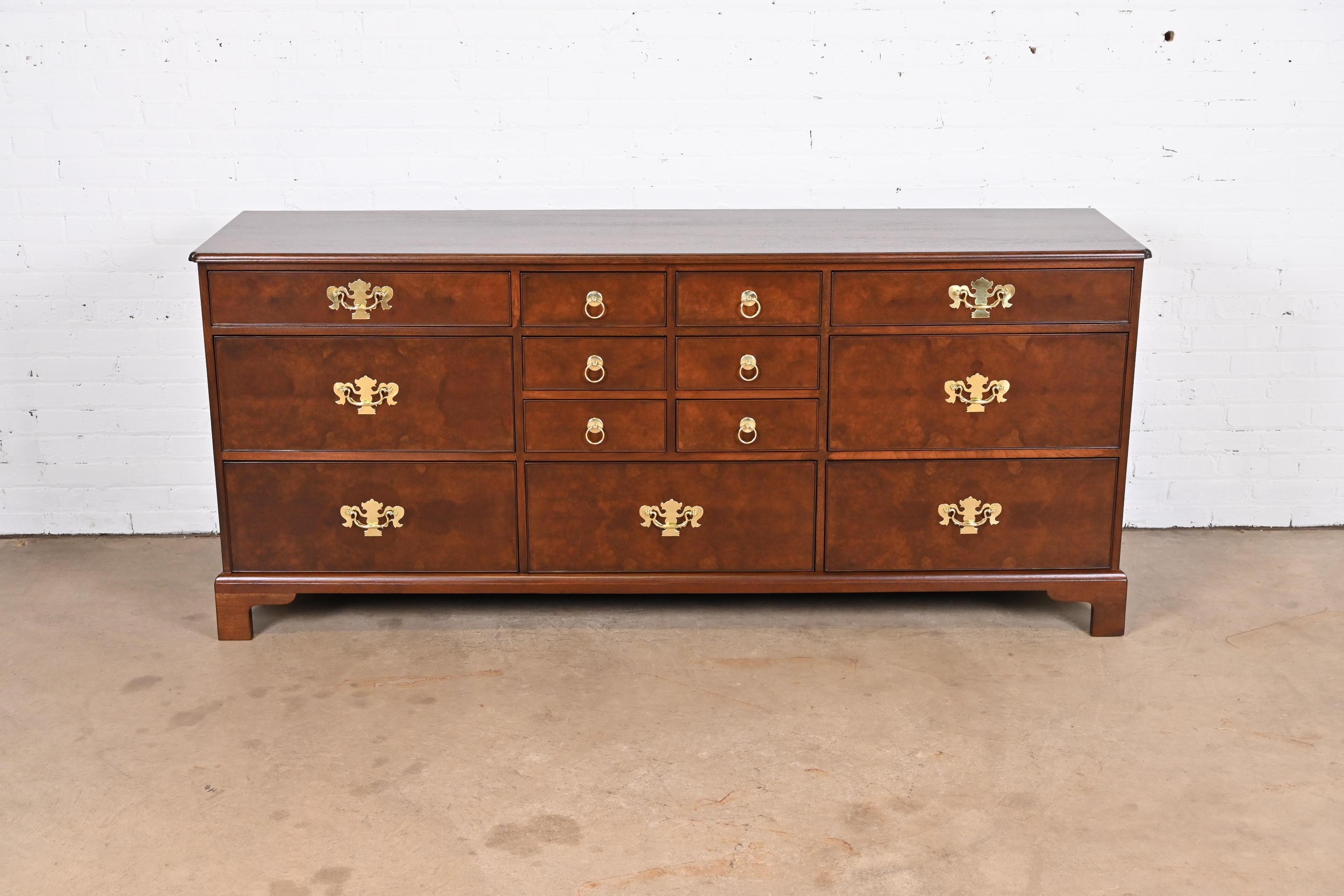 An exceptional Georgian or Chippendale style thirteen-drawer bureau dresser or credenza

By Kittinger

USA, Mid-20th Century

Solid walnut, with gorgeous burled walnut drawer fronts, and original brass hardware.

Measures: 78.63