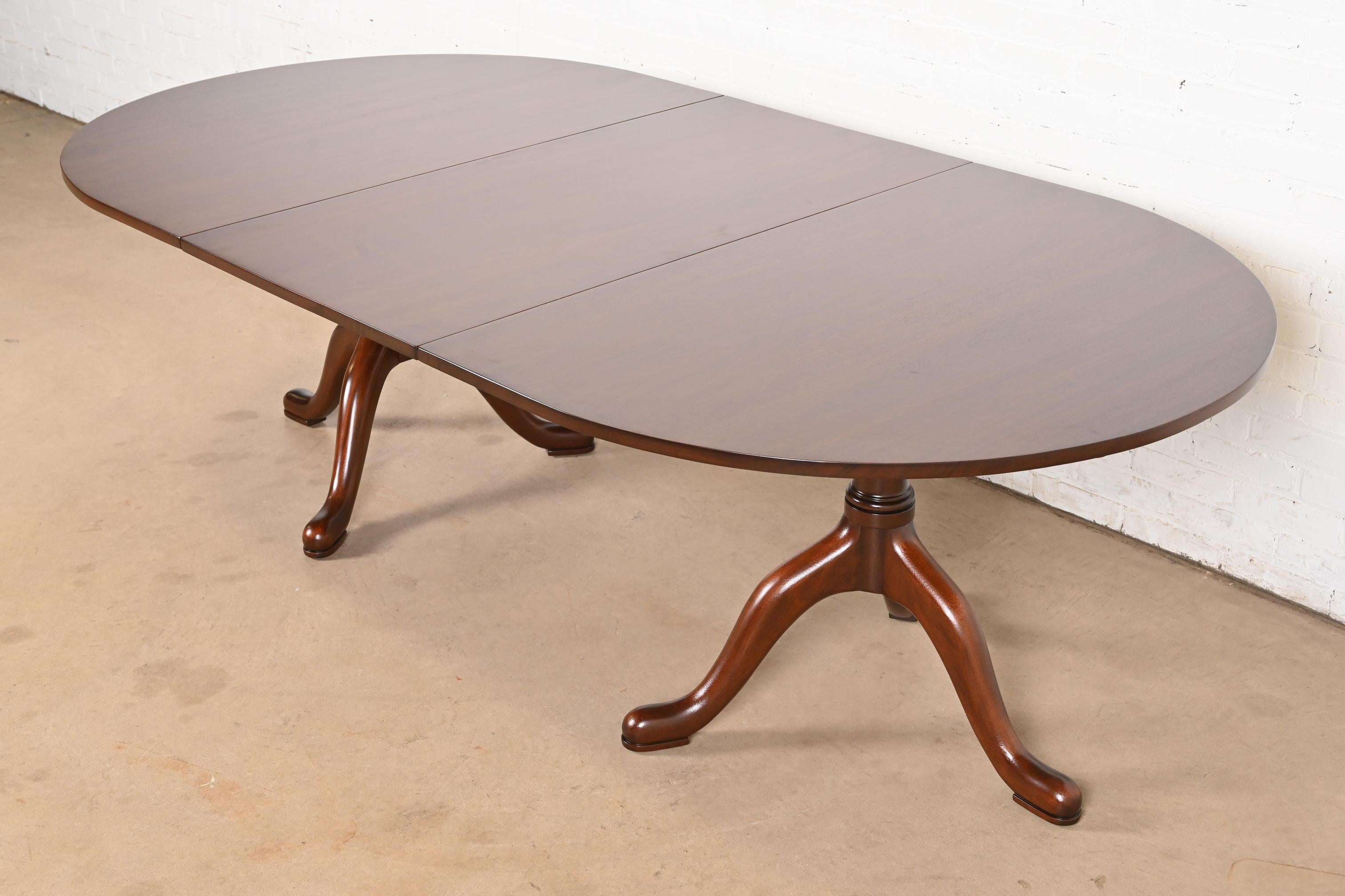 A gorgeous Georgian, Regency, or Queen Anne style solid mahogany double pedestal extension dining table

By Kittinger, 