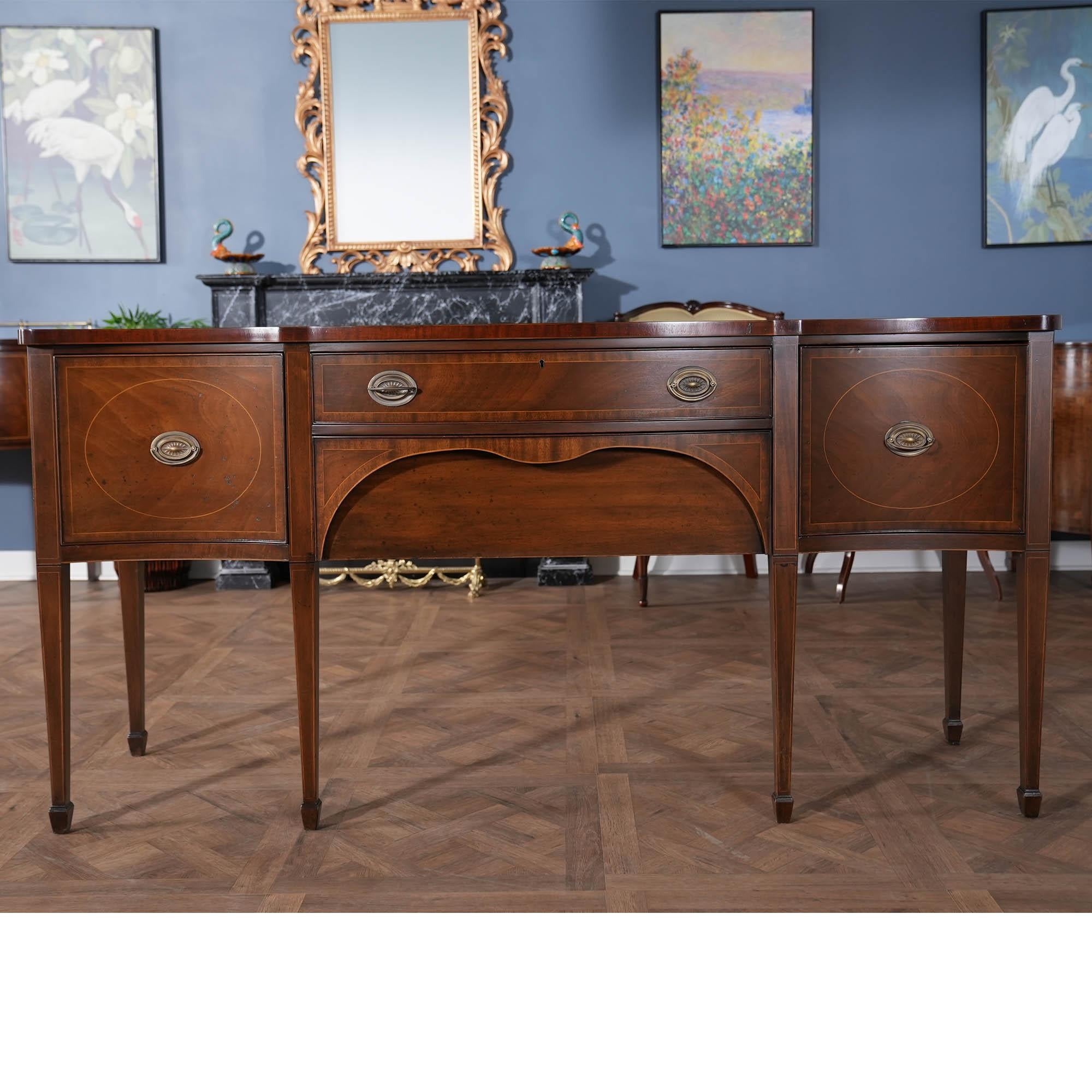 The absolute highest quality piece of American cabinet making is exemplified in this VINTAGE Kittinger Hepplewhite Style Sideboard. From the recently French polished top to the base of this cabinet all of the components work together to create a