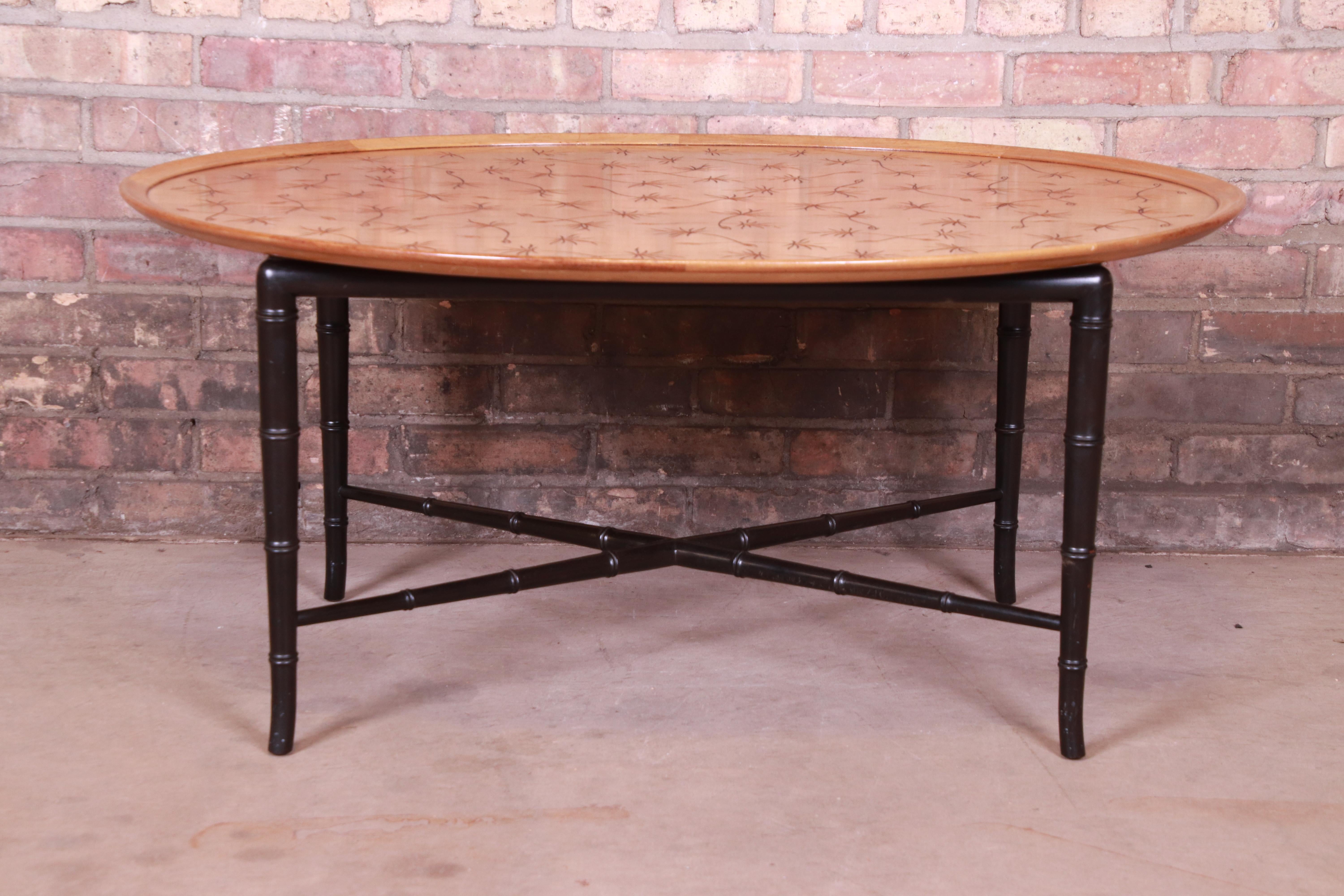 An exceptional Mid-Century Modern Hollywood Regency coffee or cocktail table

By Kittinger

USA, circa 1950s

Walnut top with unique incised thistle design, and black lacquered faux bamboo legs and stretchers.

Measures: 39.25