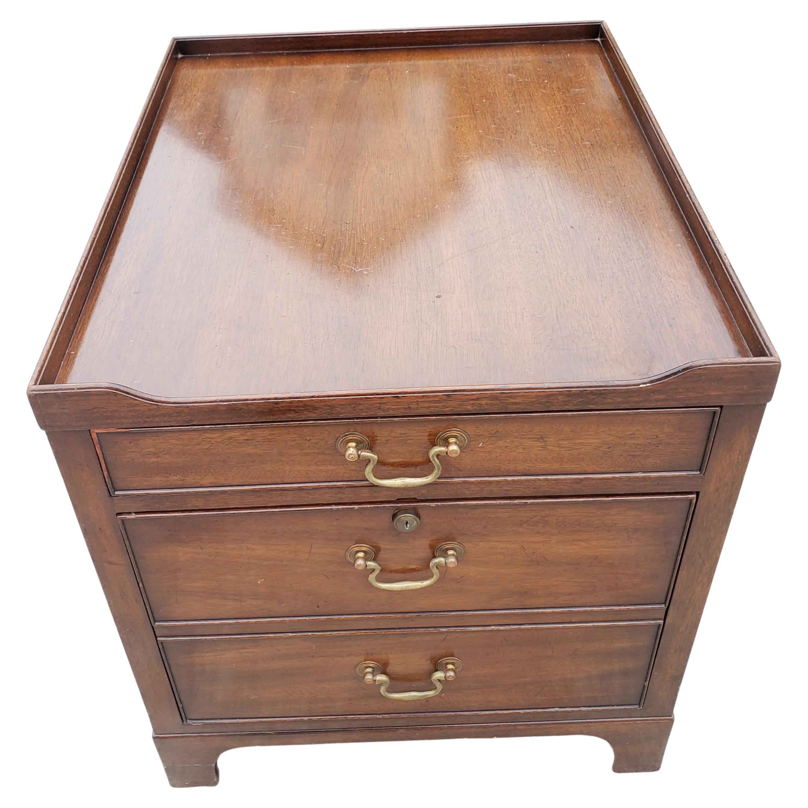 Kittinger mahogany end table that is also a file cabinet. Built to hold large files (legal size) as well as regular size (letter). Very solid construction. Very deep drawers to hold good amount of files. Drawers functioning perfectly. Good vintage
