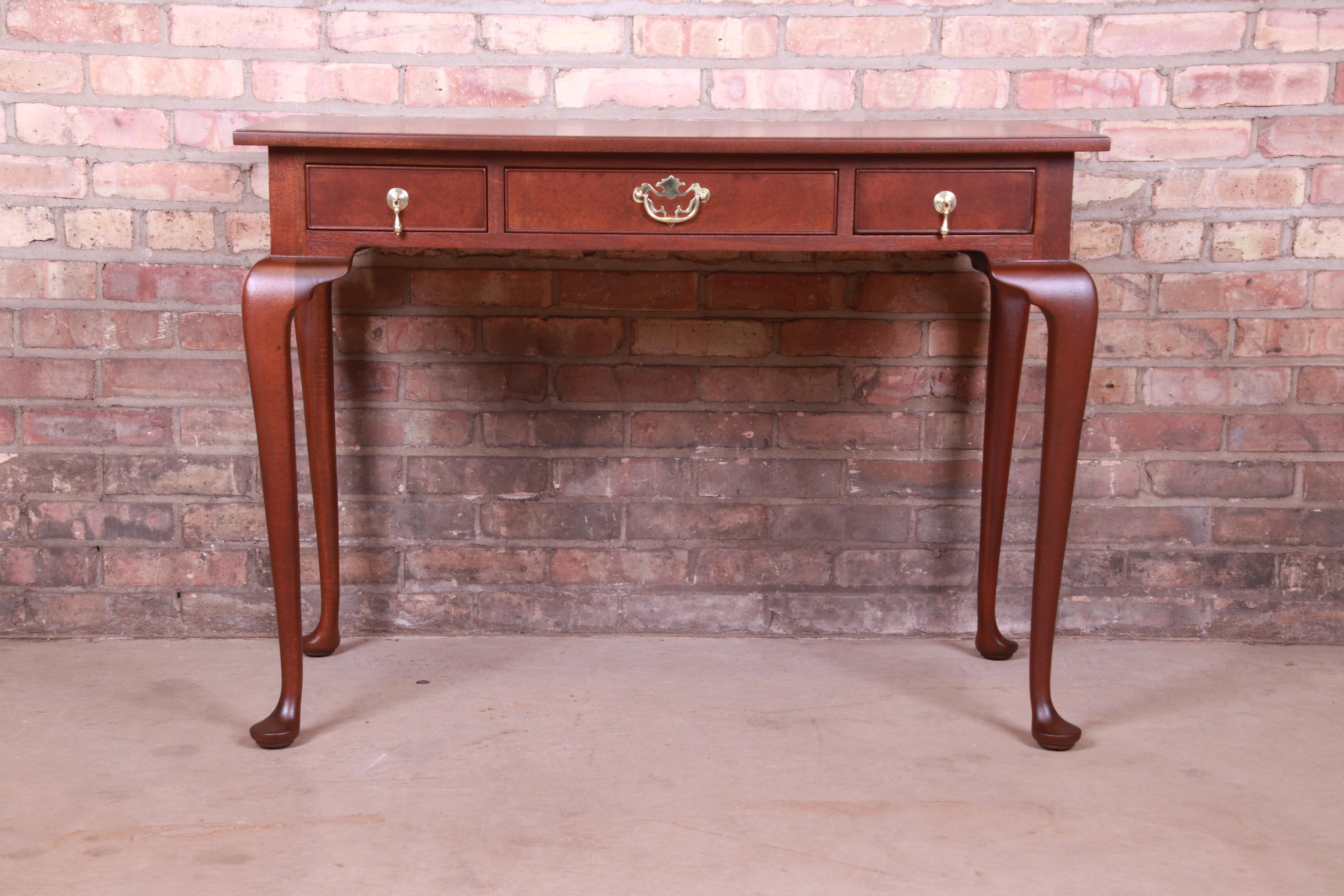 An exceptional Queen Anne style writing desk or console table

By Kittinger

USA, Circa 1960s

Carved mahogany, with original brass hardware.

Measures: 40.25