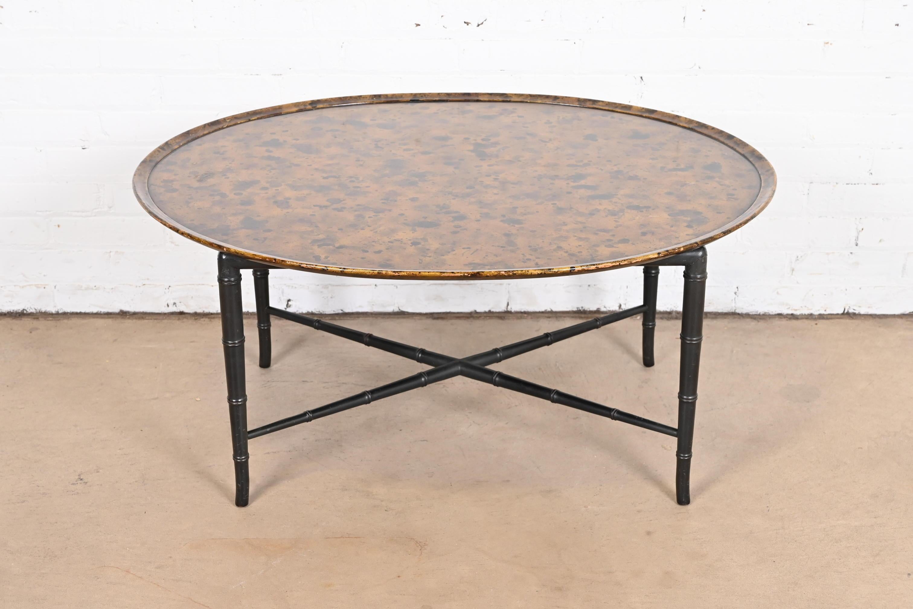 A gorgeous Regency style coffee or cocktail table

By Kittinger

USA, Mid-20th century

Black lacquered bamboo form legs and stretchers, with unique painted copper finish top.

Measures: 39.25