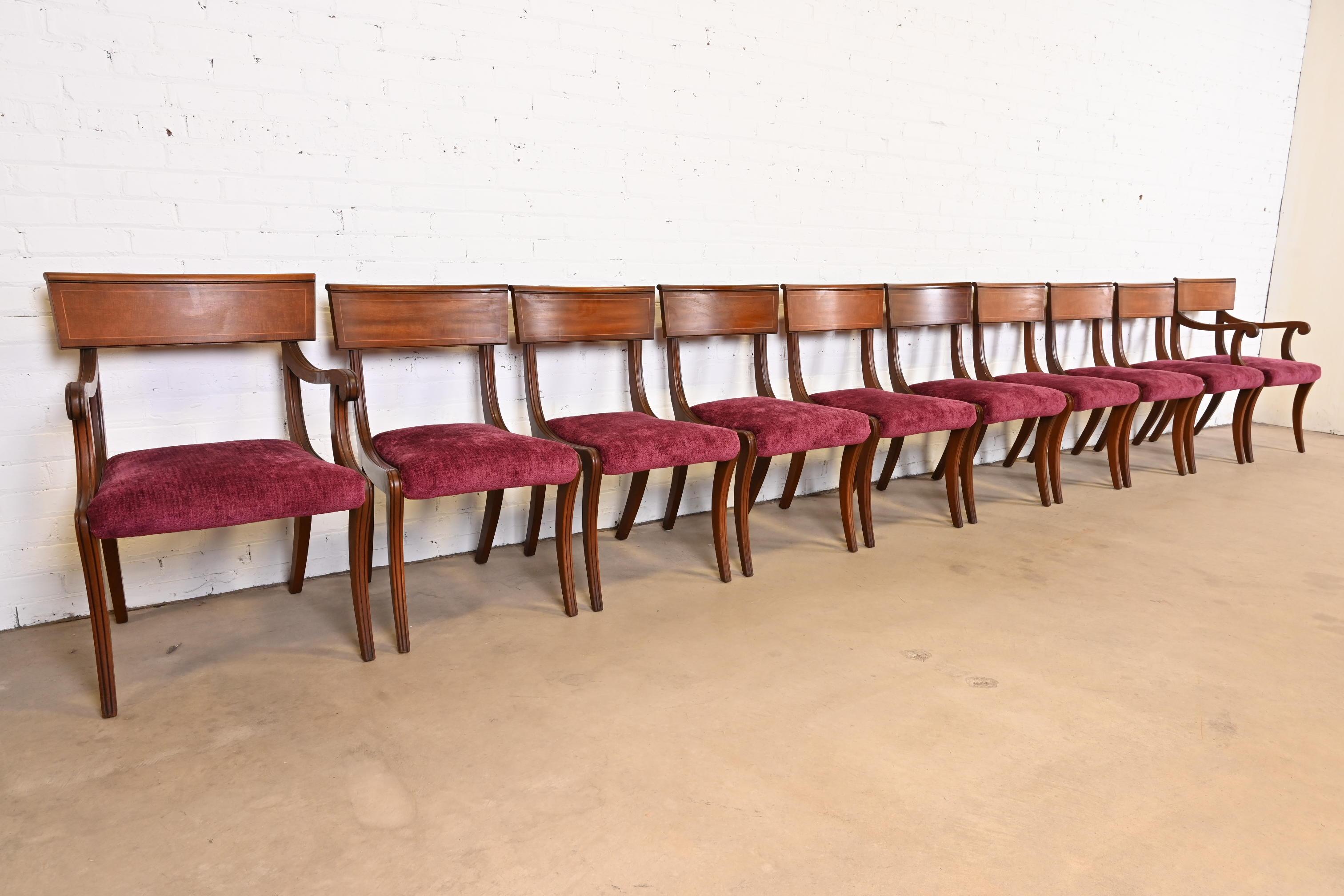 An outstanding set of ten Regency style Klismos dining chairs

By Kittinger

USA, circa 1960s

Elegant sculpted mahogany frames, with satinwood string inlay and upholstered seats.

Measures:
Side chairs - 19