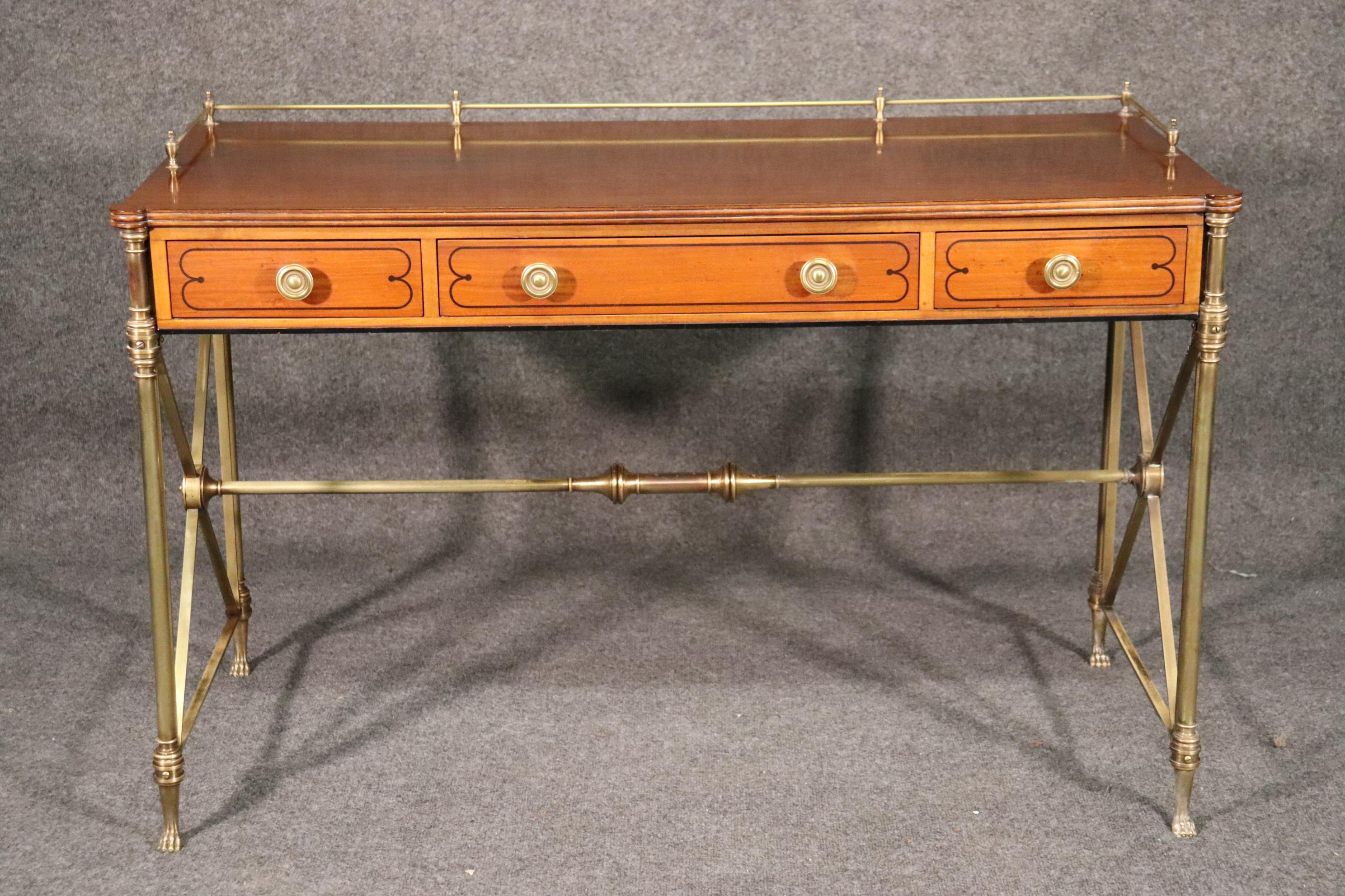 This is a very rare Kittinger of Buffalo, NY directoire style desk. The desk is in good condition with beautiful polished brass and a satinwood case. The case is inlaid in ebony and is in good vintage condition. The desk measures 47 wide x 22 deep x