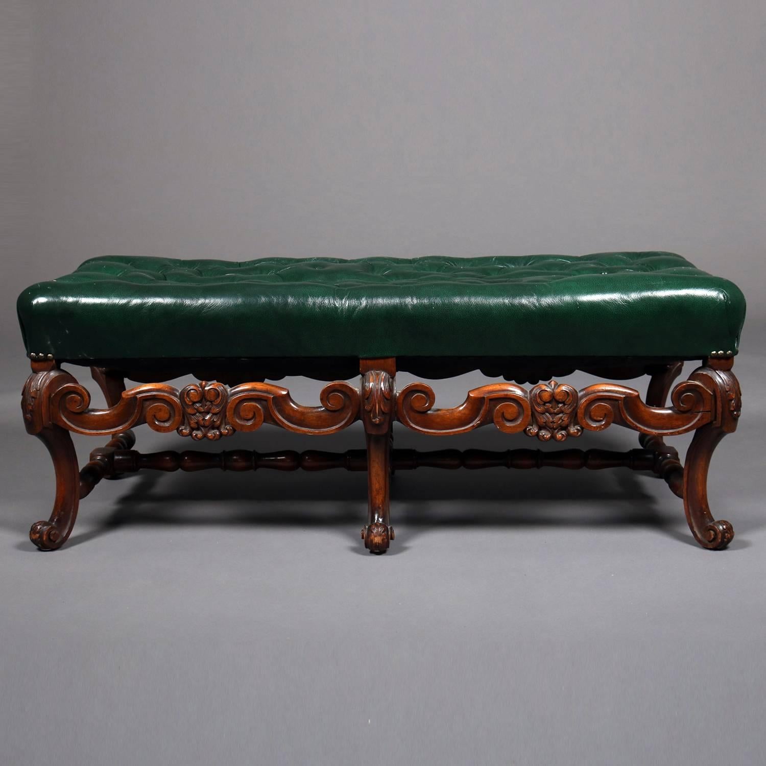 Kittinger style Continental bench features button tufted green leather upper over carved walnut frame with six scroll form cabriole legs, circa 1900

Measures: 16