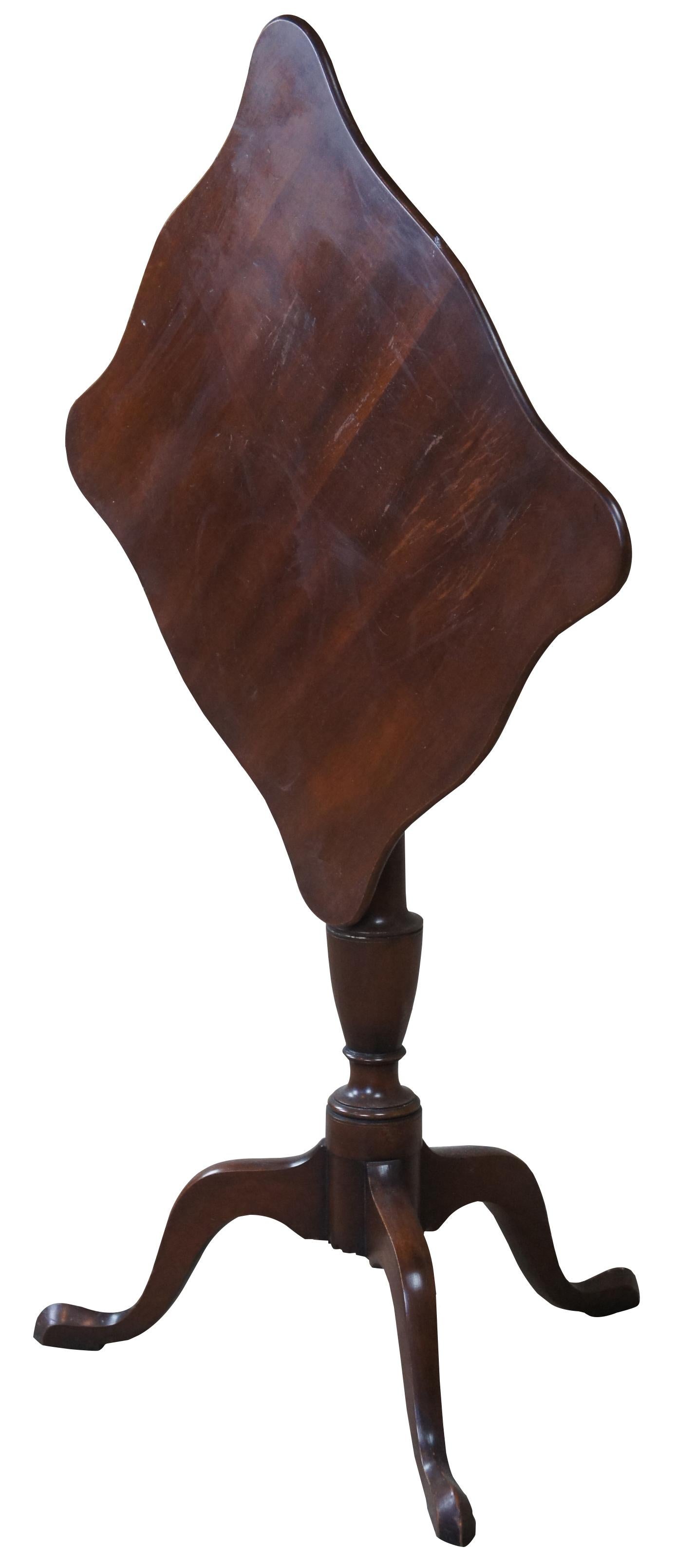 A Federal style mahogany candle stand by Kittinger, circa 1970s. Williamburg Restoration line. Features a rectangular top with serpentine edge over a baluster turned base with cabriole legs leading to pad feet.

Provenance: Estate of Carol Levitan