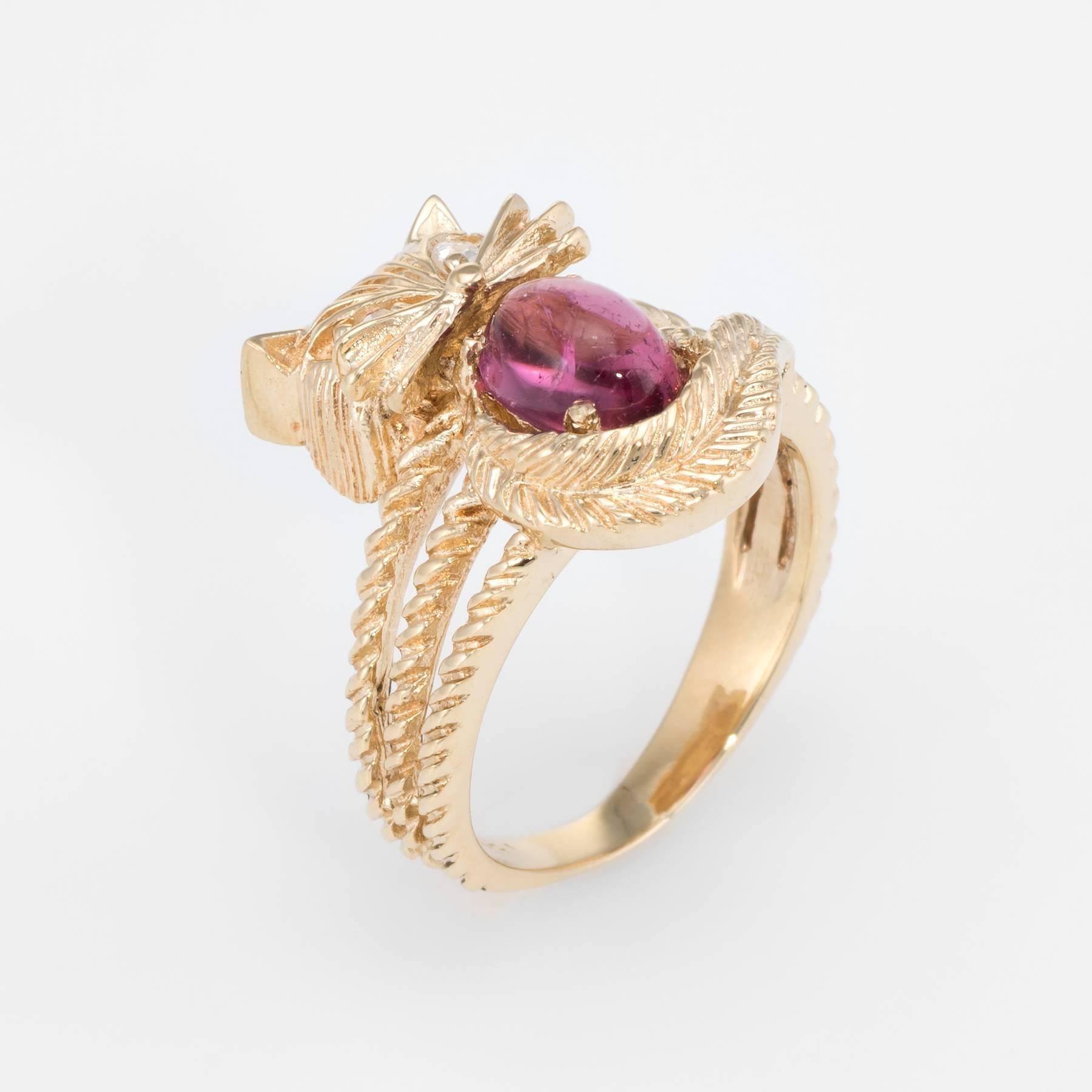 Finely detailed vintage kitty cat ring, crafted in 14 karat yellow gold. 

Oval cabochon cut pink tourmaline measures 6.5mm x 5mm (estimated at 1.50 carats), accented with an estimated 0.02 carats of single cut diamonds (estimated at H color and