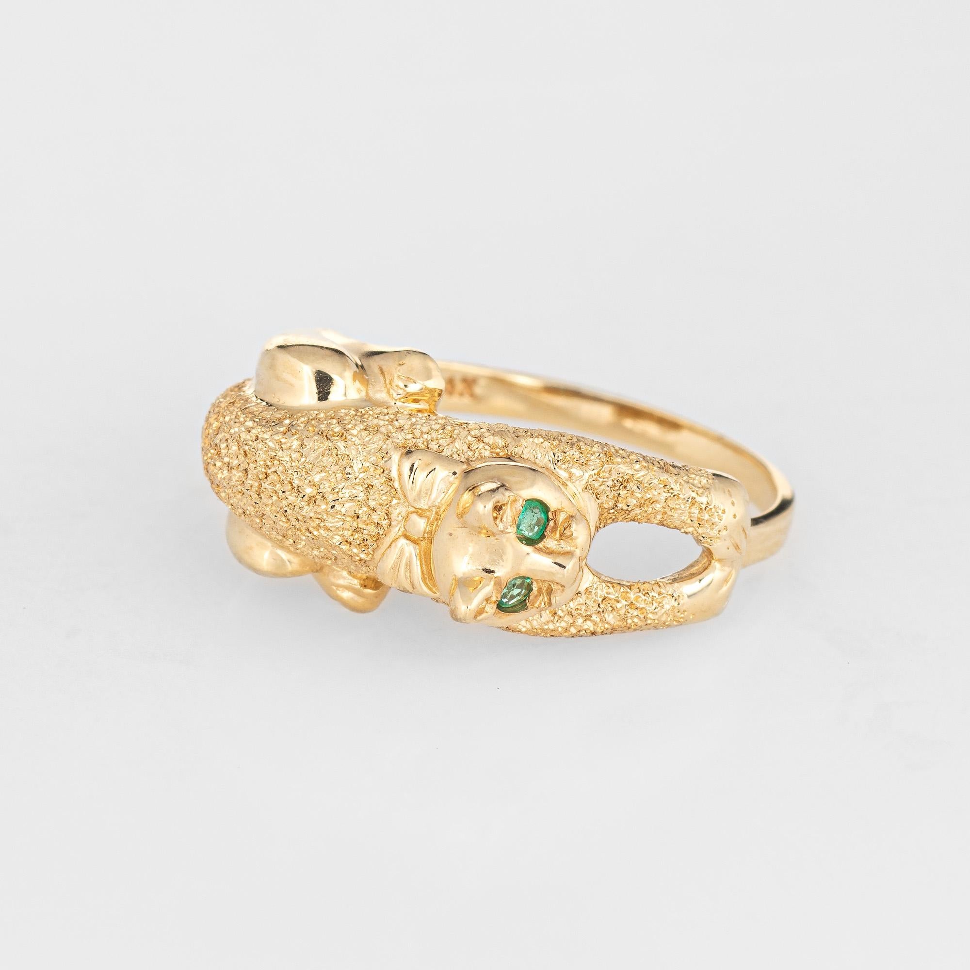 Stylish estate kitty cat ring crafted in 14 karat yellow gold. 

Two emeralds total an estimated 0.02 carats. 

The kitty cat features emerald eyes with a textured body that offers a subtle shimmer. The cat hugs the finger in what appears to be a