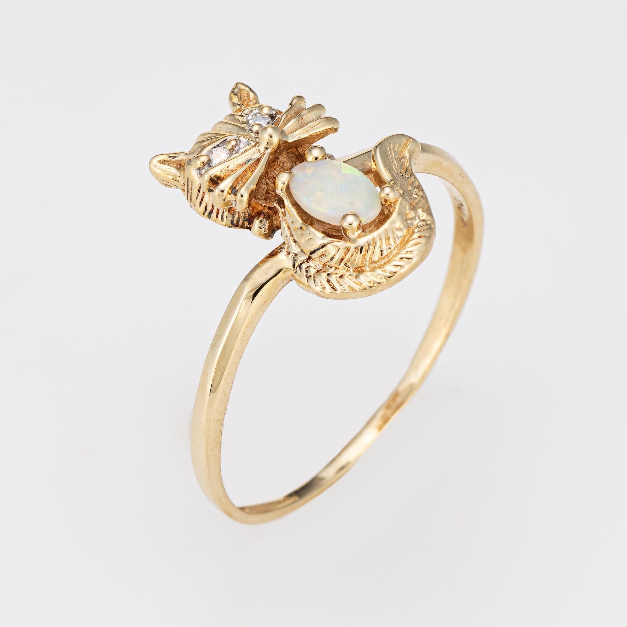Sweet vintage kitty cat ring crafted in 10 karat yellow gold. 

Cabochon cut opal measures 5mm x 3mm. Two small diamonds total an estimated 0.01 carats (estimated at H-I color SI2-I1 clarity). 

The nicely detailed kitty cat features diamond set