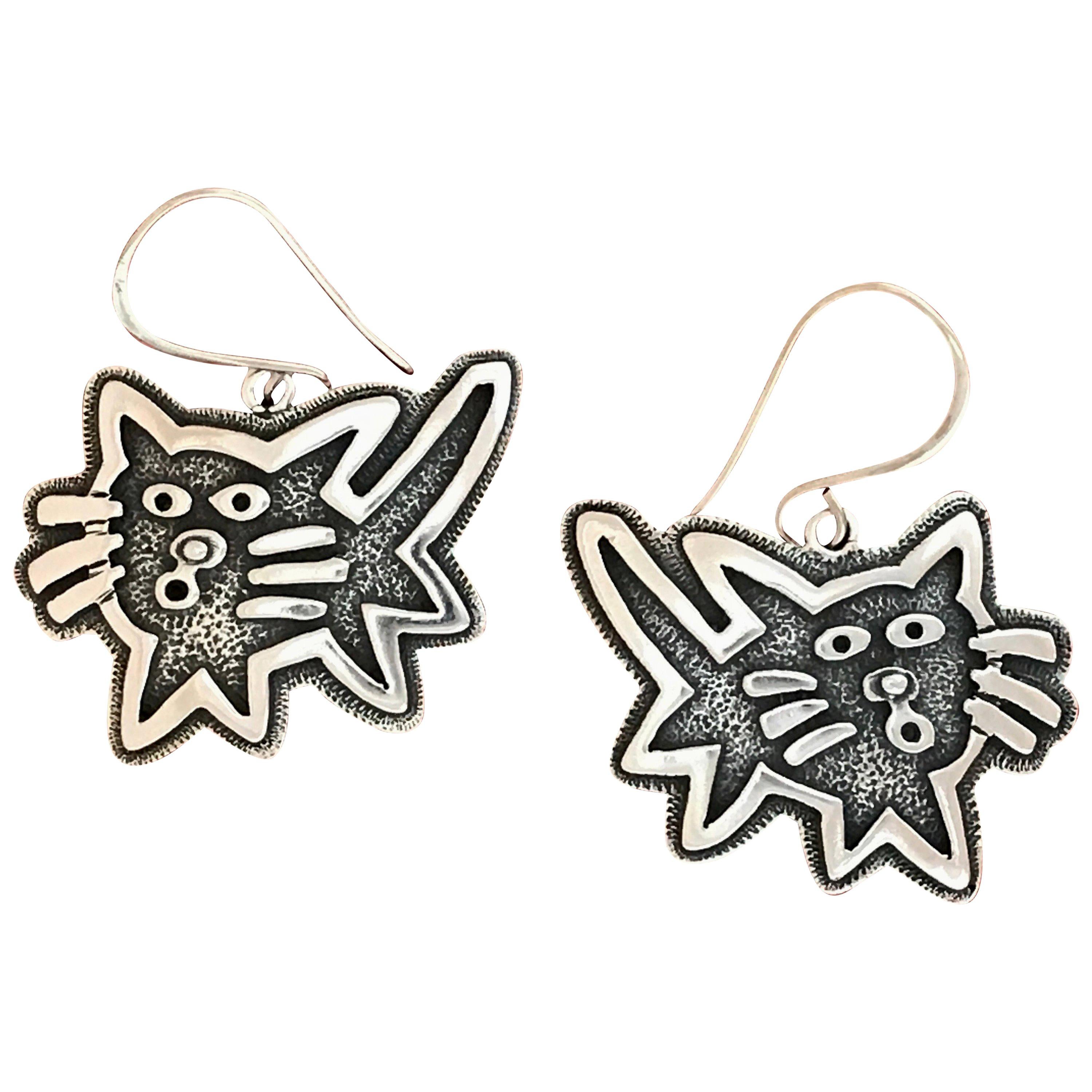 Kitty earrings cast sterling silver Melanie Yazzie dangle cats contemporary
Sterling Silver casting  Melanie A. Yazzie (Navajo-Diné) is a highly regarded multimedia artist known for her printmaking, paintings, sculpture, and jewelry designs. She has