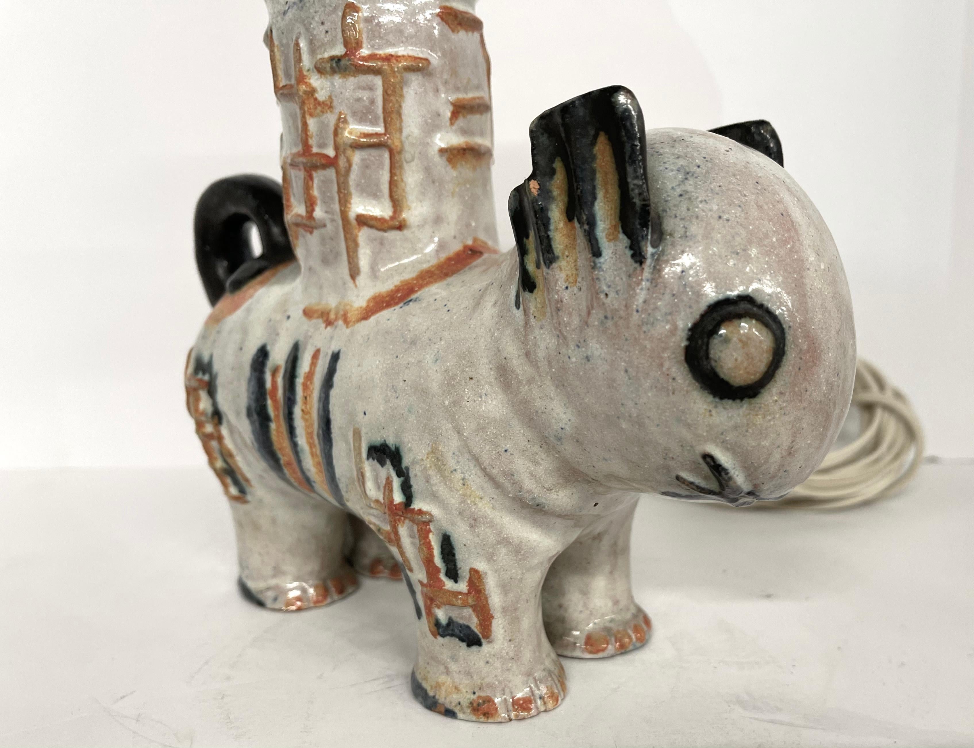 A wonderful ceramic, pottery cat designed by Kitty Rix and executed by the Wiener Werkstatte in the late 1920's. It was produced as a lamp and has an old leviton fixture and some newer wiring. In good original condition with no chips that I have