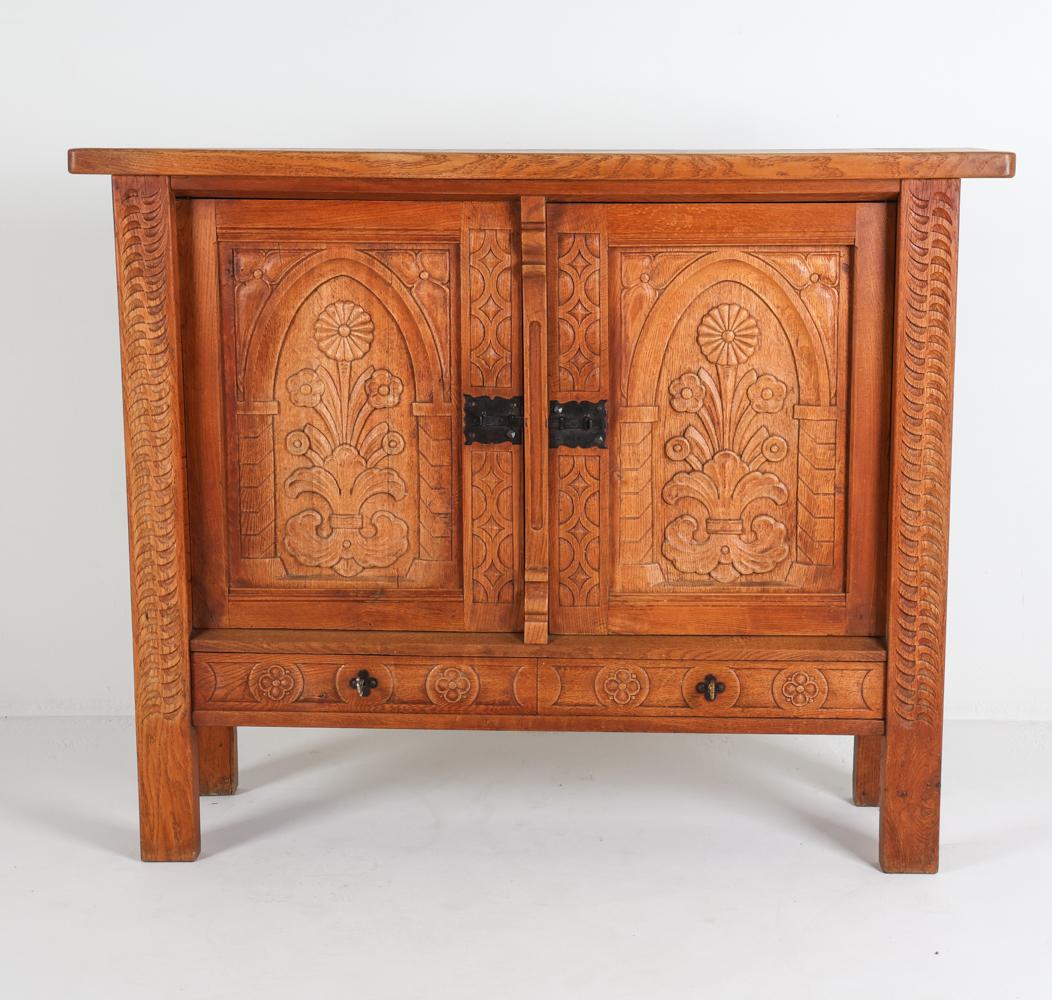 This sideboard stands as a beautiful example for Danish Brutalist style. With an appearance that is evocative of work of Henry 'Henning' Kjaernulf, this piece displayed intricate and beautiful carvings on the cabinet door panels and legs. The carved
