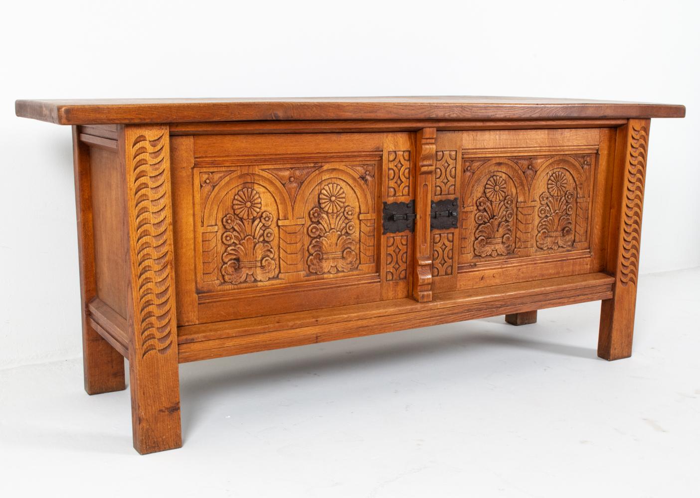 This stunning sideboard is a work of art in its own right, made from solid oak wood with intricate hand-carved decoration throughout. In the manner of the notorious Henry 'Henning' Kjaernulf, this oak sideboard is a great example of Danish