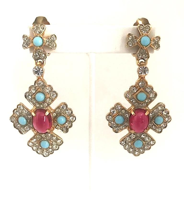 From the late 1960s to early 1970s is this pair of beautiful early Kenneth Jay Lane medallion pendant earrings. The faux glass turquoise and ruby cabochons are nicely off set by the sparkle of the crystal rhinestones.  Each earring measures 1.38