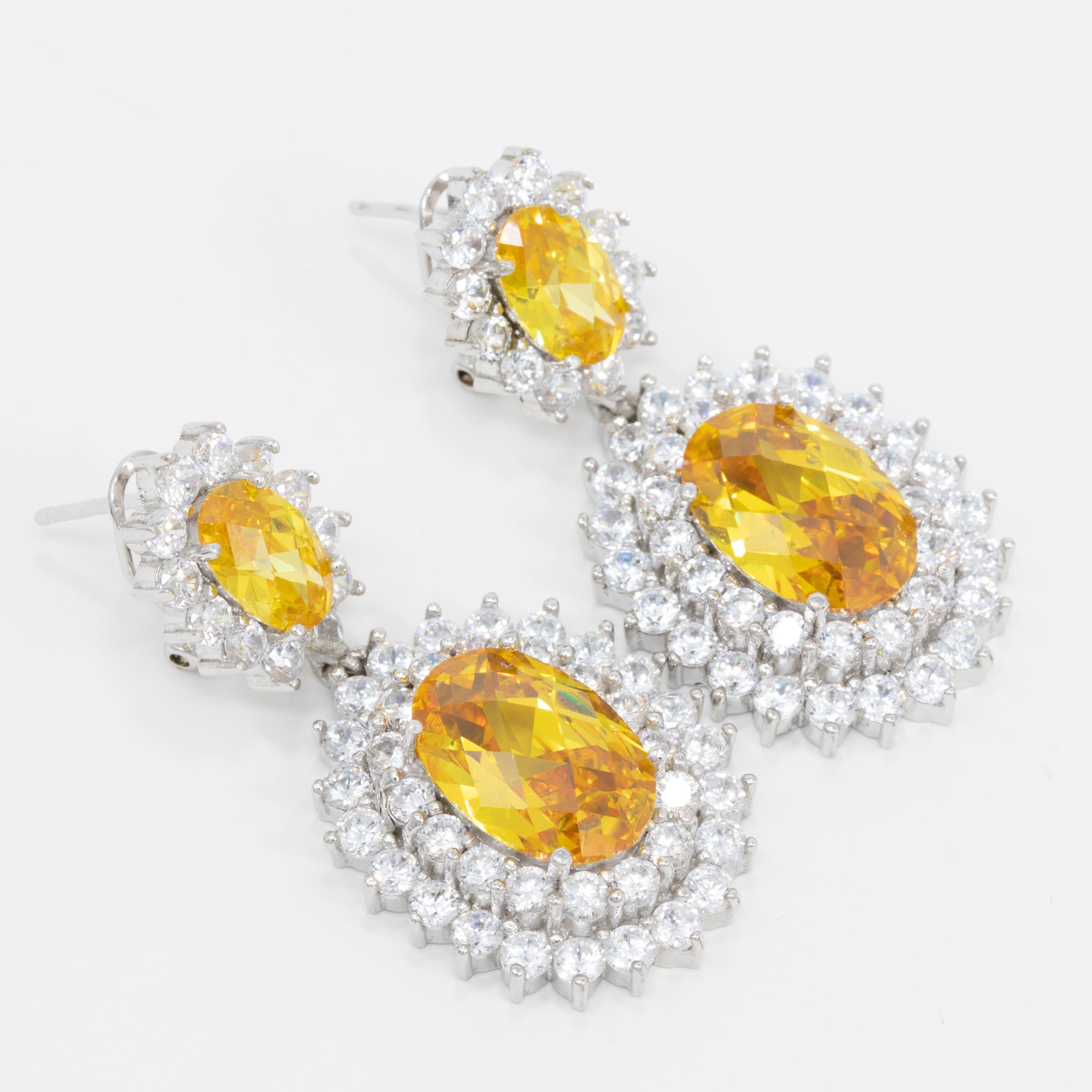 This dramatic and dazzling drop design sparkles with canary and clear cubic zirconia crystals. From Kenneth Jay Lane's CZ collection.

Rhodium Plated Brass. Post with Friction.

Tags, Marks, Hallmarks: KJL 

Designed in New York. Made in China.