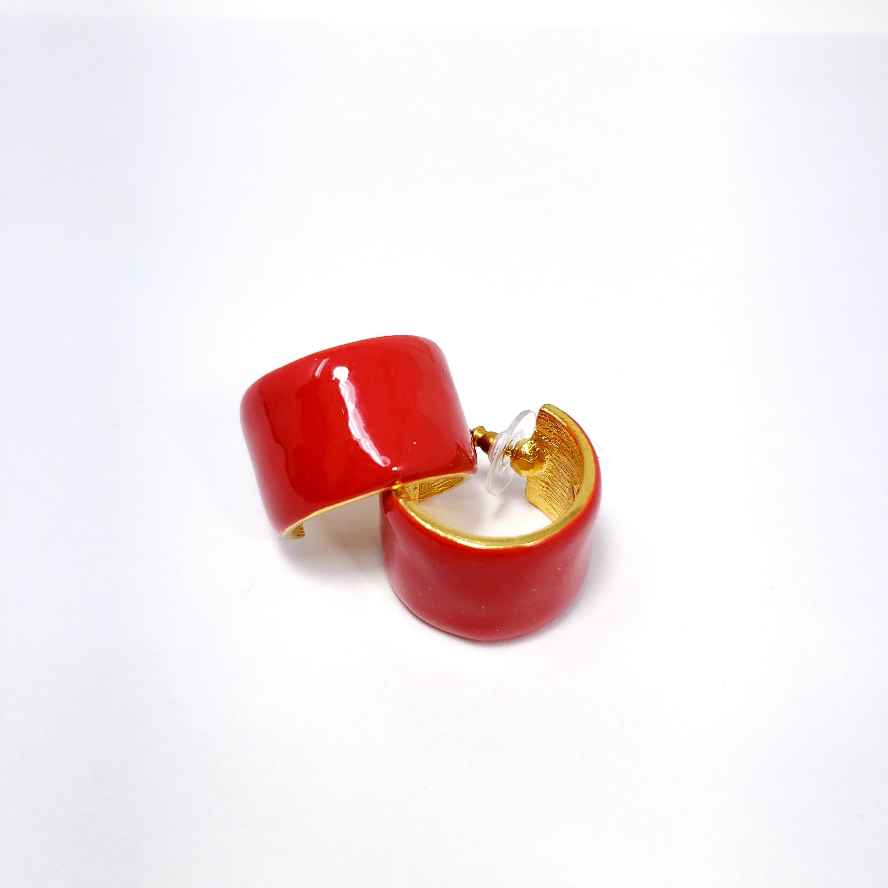 A pair of stylish golden earrings painted bright cherry red enamel. Sophisticated hoop-inspired design with a bit of flair! Kenneth Jay Lane.

Hallmarks: KJL