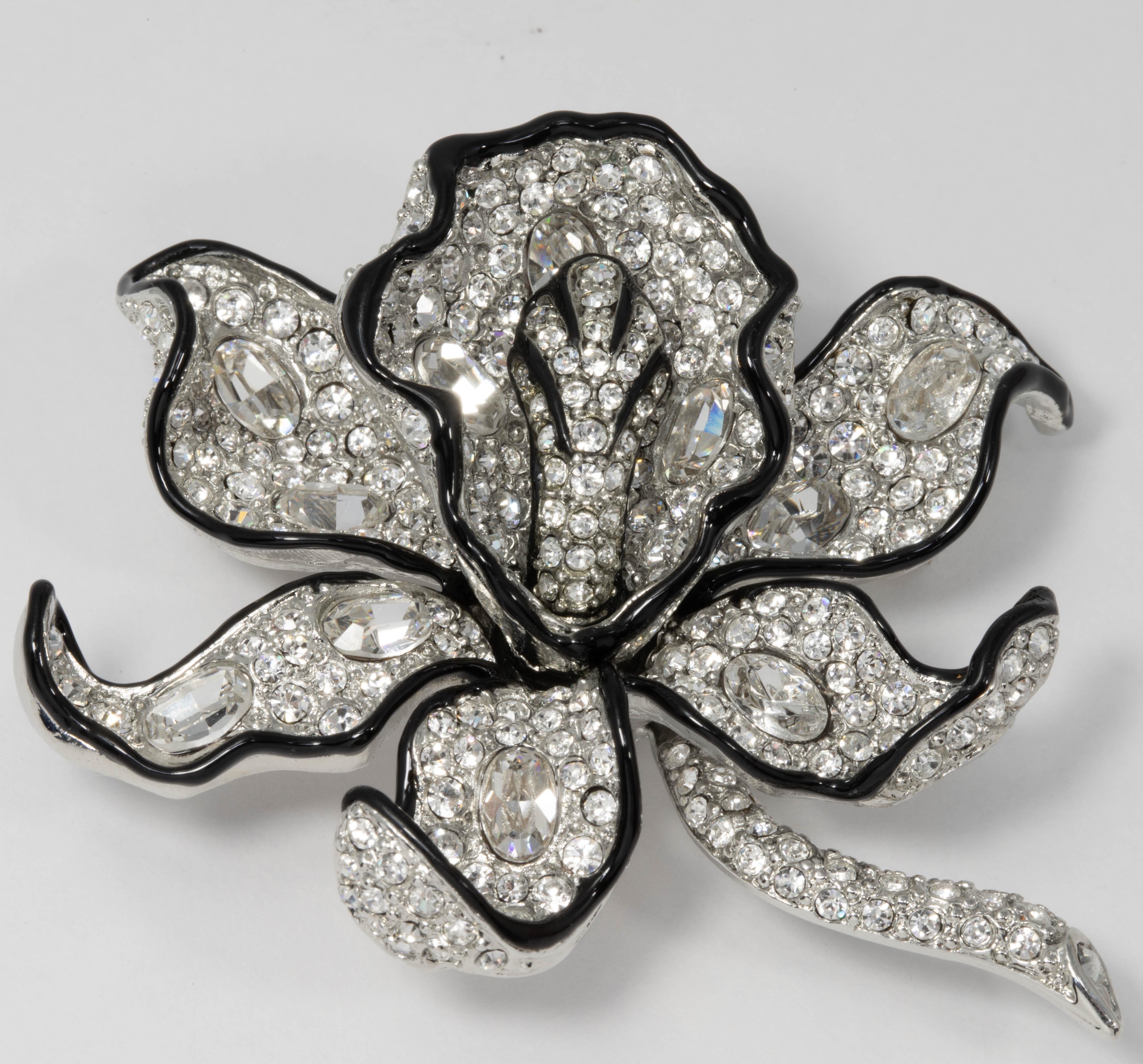 Flower chic! This pin brooch by Kenneth Jay Lane features pave clear crystals on a silvertone flower, accented with black enamel trim for a subtle contrast.

Tags, Marks, Hallmarks: Kenneth © Lane