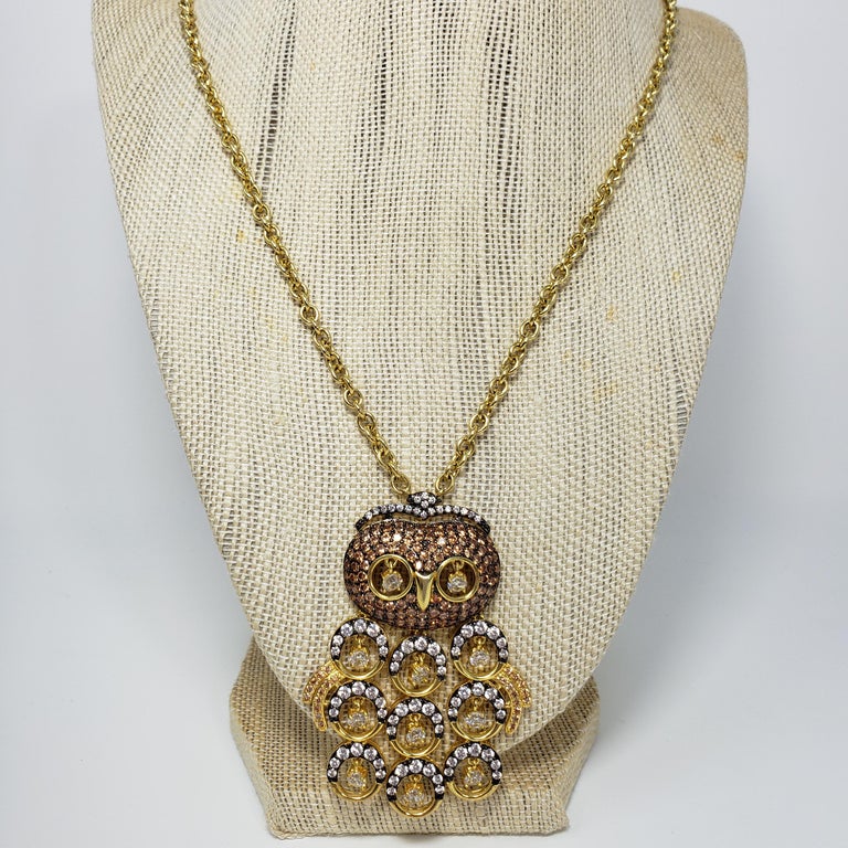 A stylish chain necklace with an embellished owl motif. Gold plated-metal, with clear and amber pave crystals and dangling accents.

CZ Cubic Zirconia line by Kenneth Jay Lane.