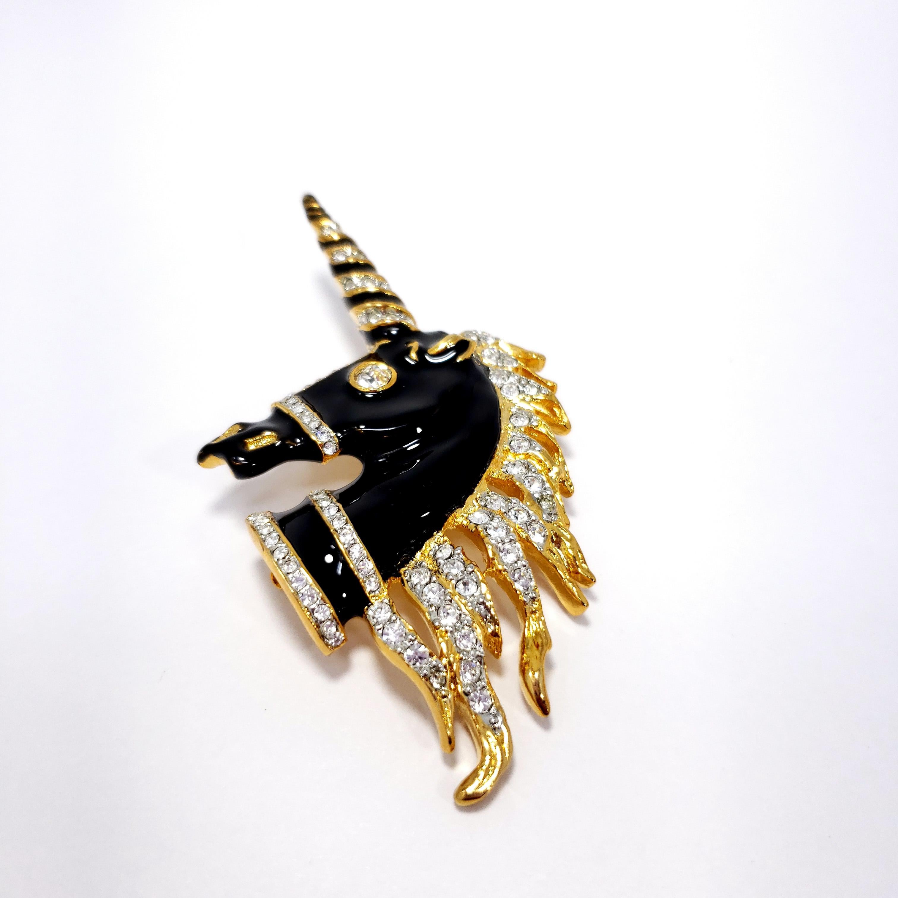 Clear crystals decorate this majestic black enamel golden unicorn pin brooch by Kenneth Jay Lane.

Hallmarks: Kenneth Lane
