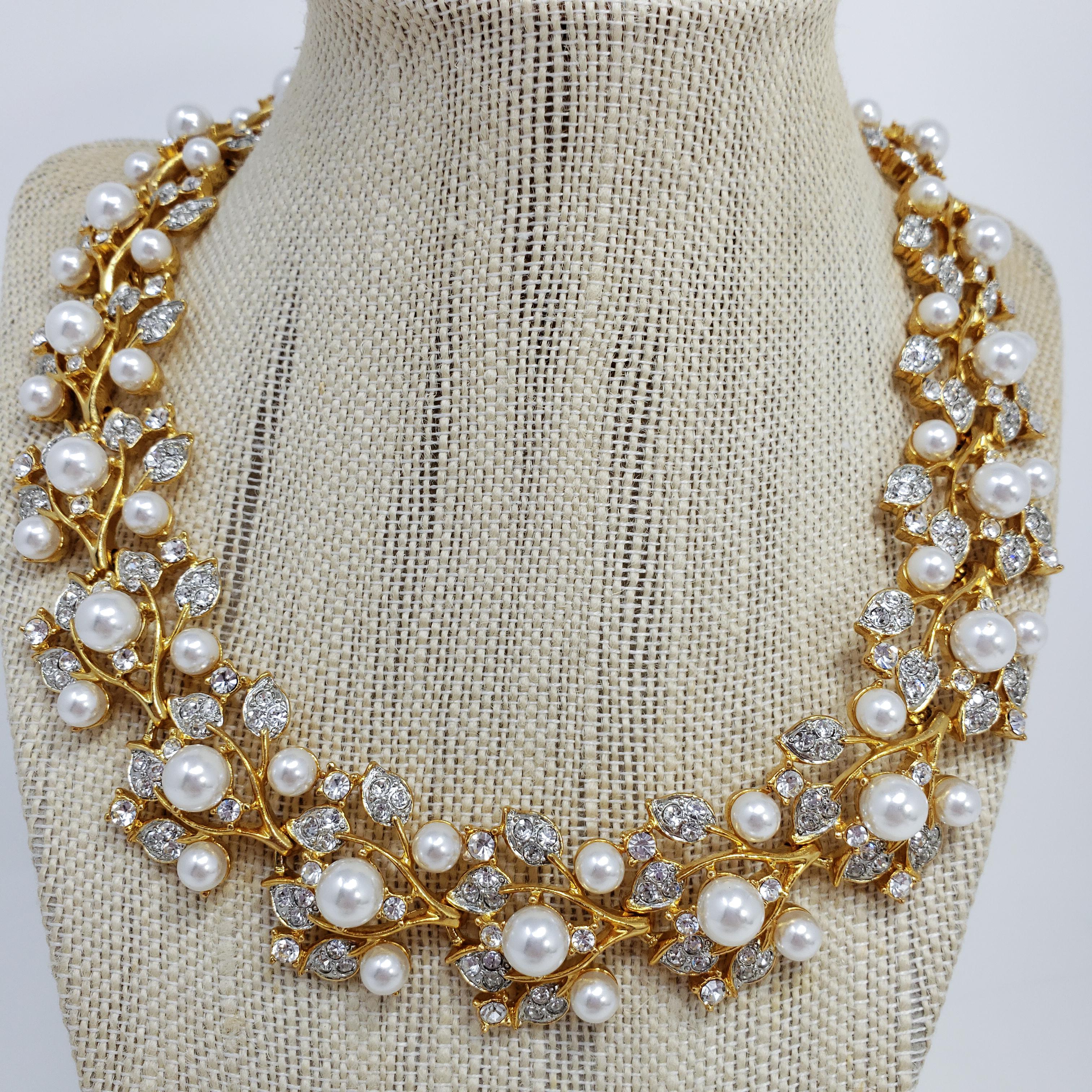 An extravagant necklace by Kenneth Jay Lane! Features flower-branch motif links, accented with clear Swarovski crystals and glass pearls. Set on gold-tone metal.

Hallmarks: Kenneth © Lane, Made in USA
Length: 46cm to 54cm (with extension chain)