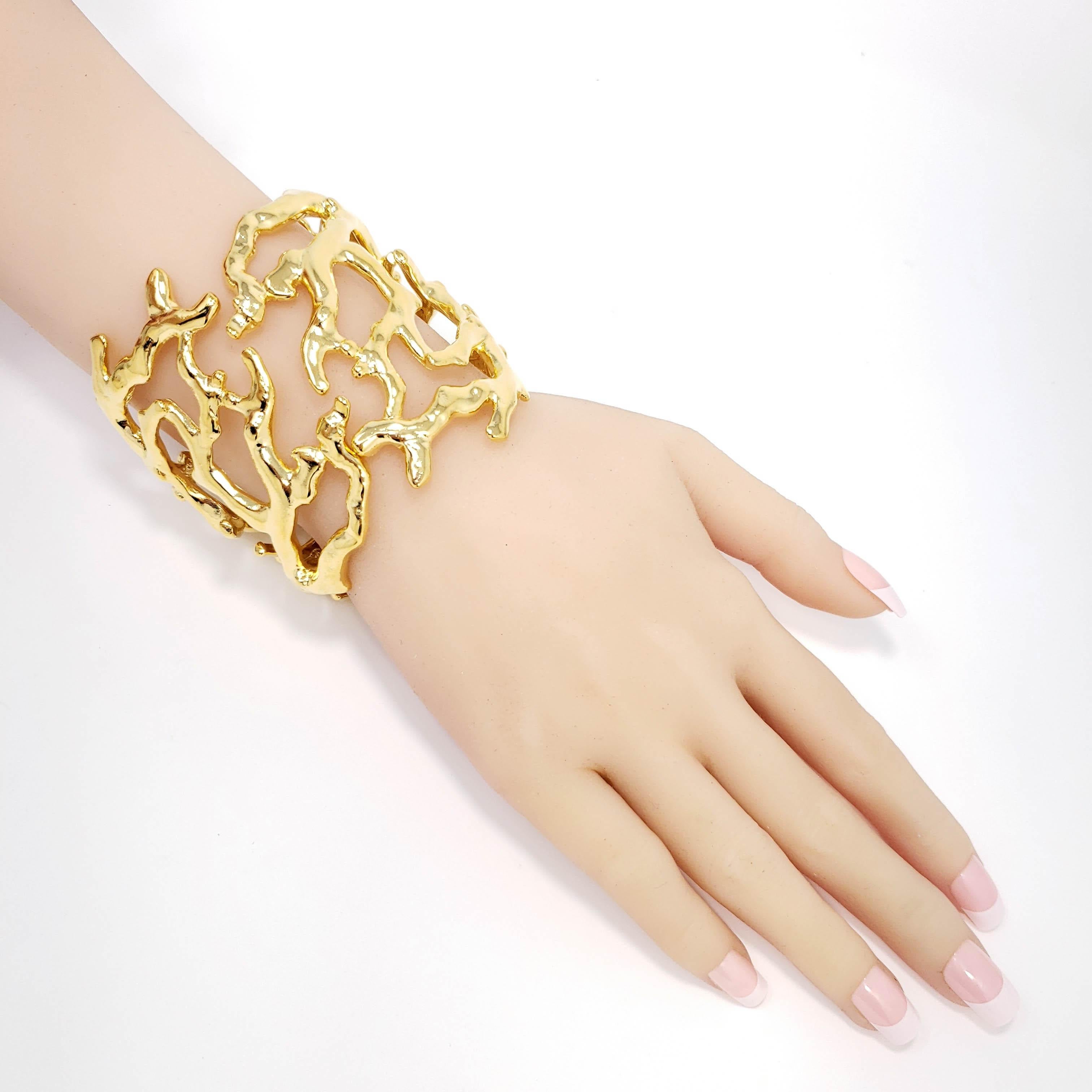More beautiful than the oceans! This nautical Kenneth Jay Lane cuff bracelet features glowing golden coral branches. 

22KT Gold plated. Hinged bangle.

Hallmarks: Kenneth Lane, Made in USA

Inner circumference: 6.5 in / 16.5 cm
Inner diameter at