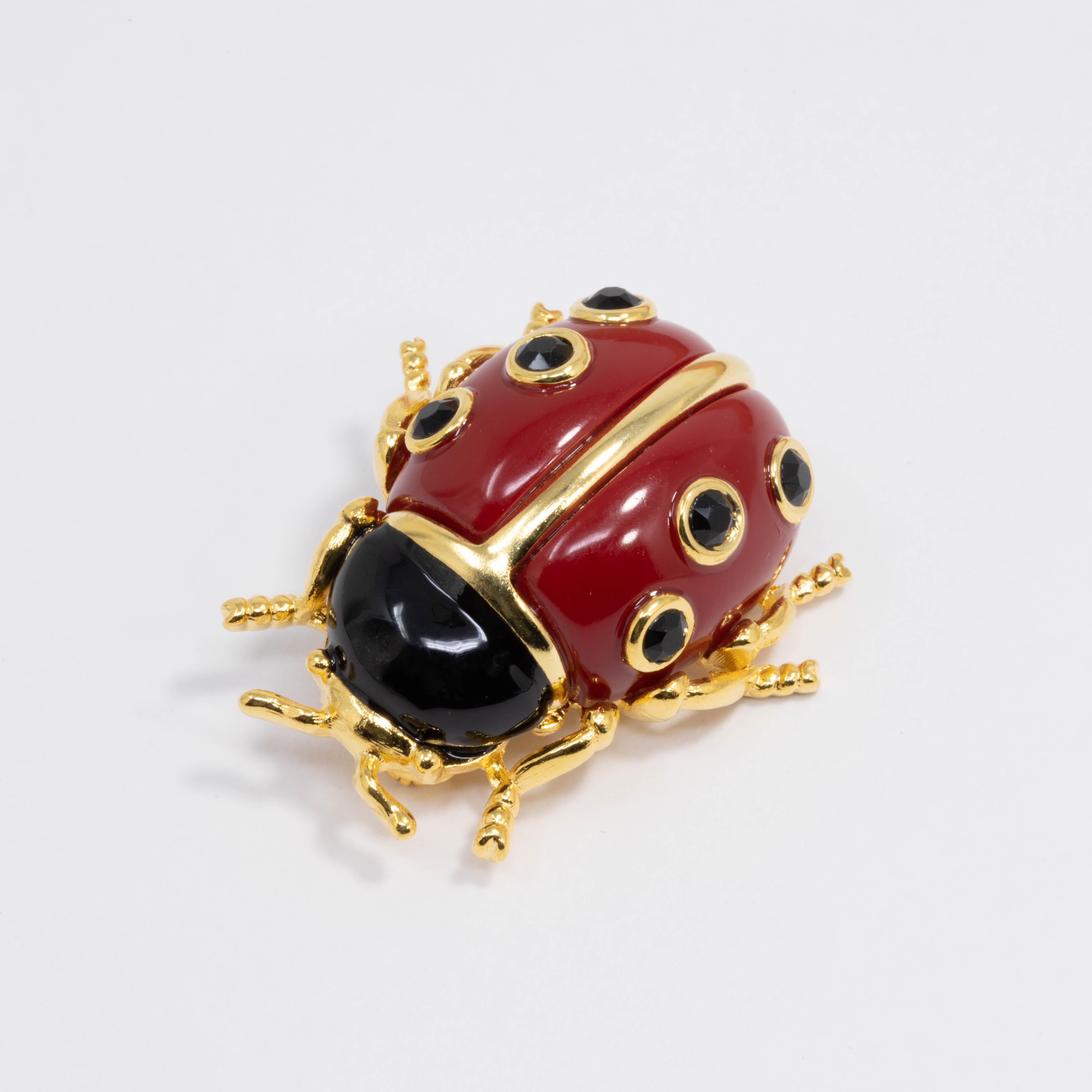 Ladybug pin brooch by Kenneth Jay Lane. This colorful critter features a golden body painted with red and black enamel.

Gold plated.

Tags, Marks, Hallmarks: KJL, Made in USA