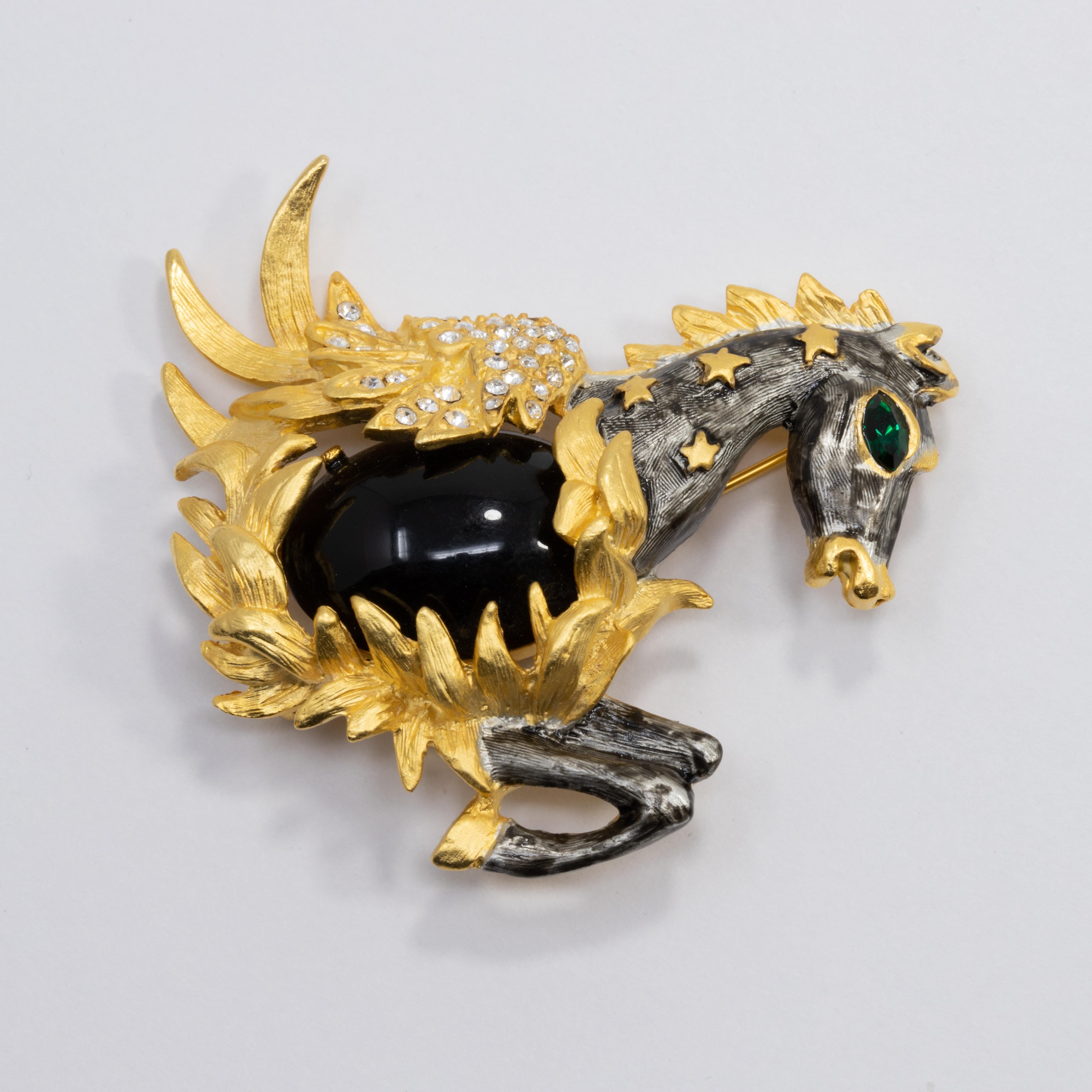 A bold and stylish pegasus pin by Kenneth Jay Lane! Features a painted dark gray horse with golden wings, accented with pave crystals and a centerpiece black cabochon.

Hallmarks: Kenneth © Lane
